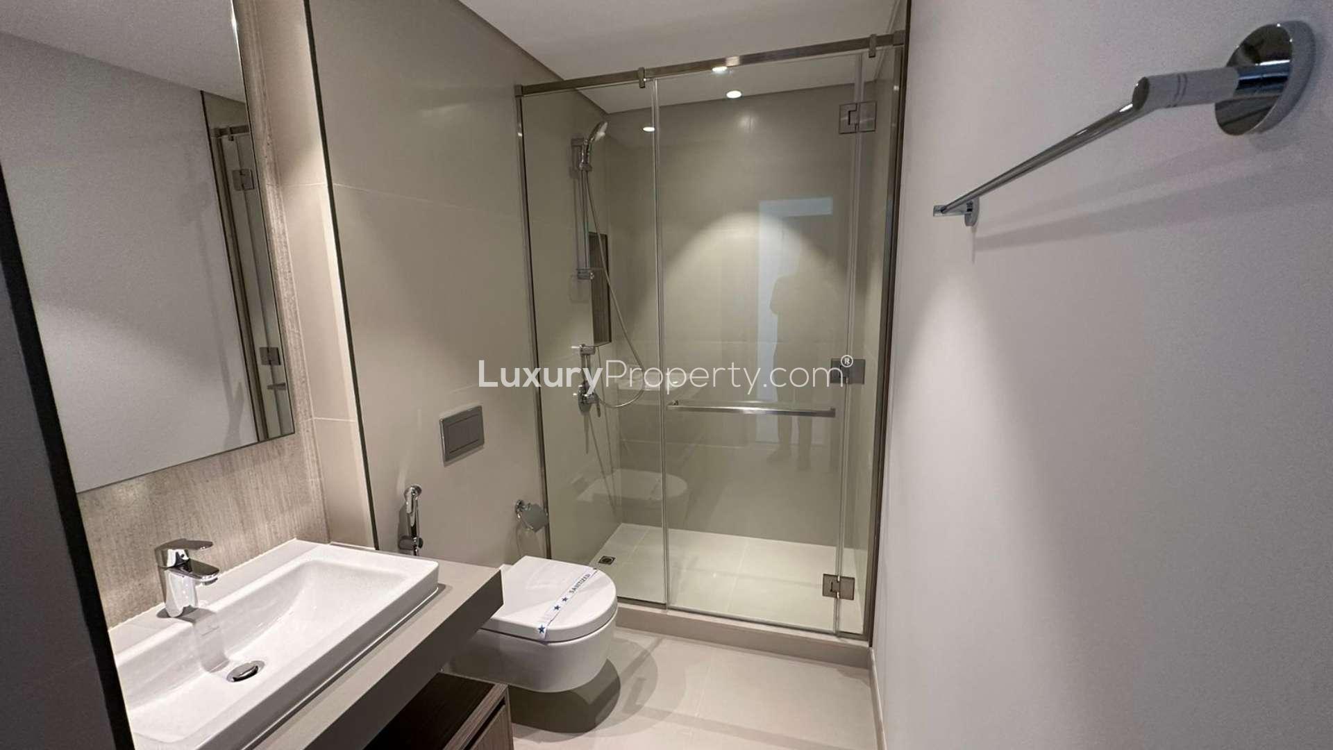 Empty bedroom with large window showcasing Burj Khalifa view in The Grand, Creek Harbour