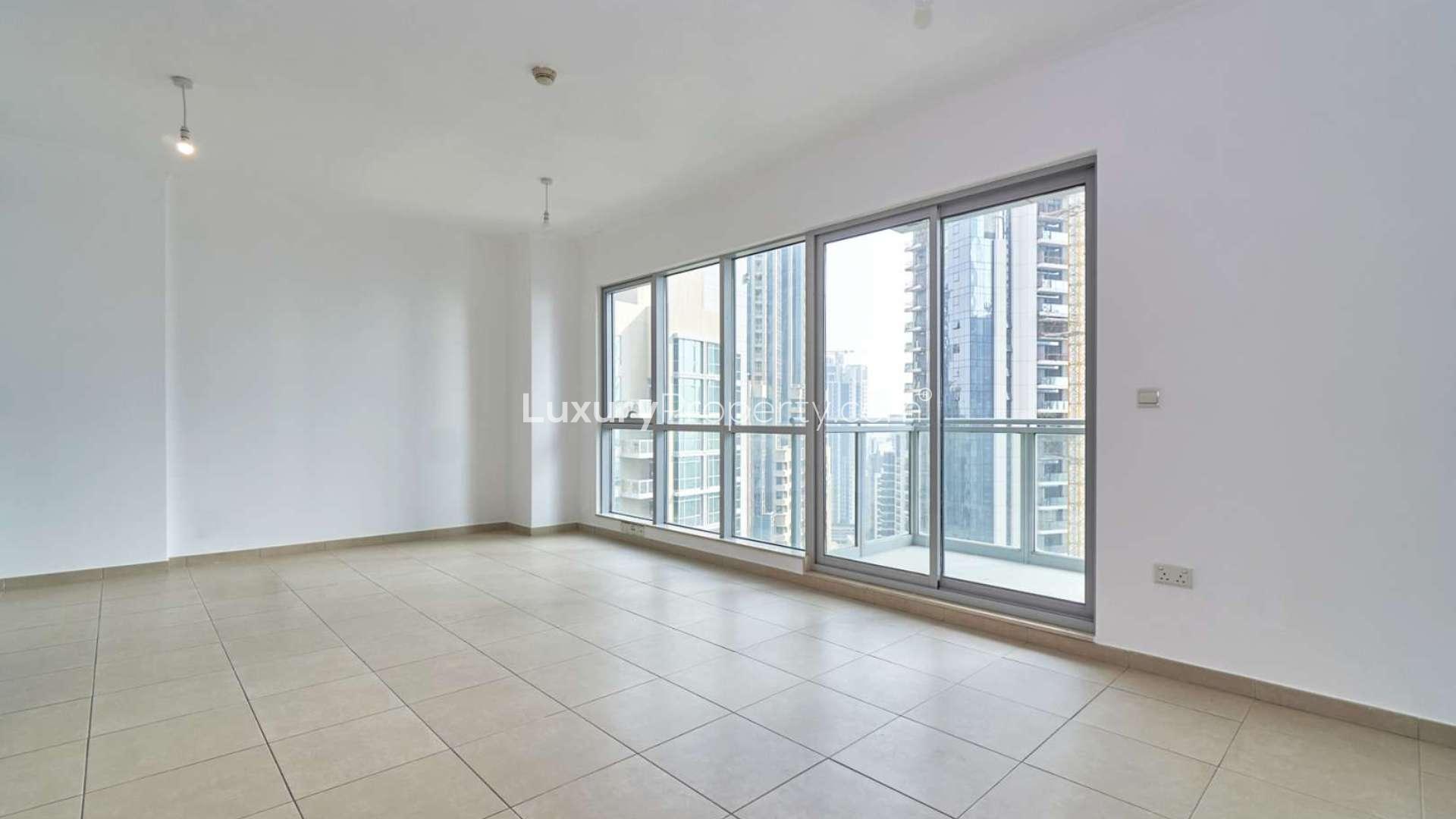 Empty living area with tiled floor and wooden accents in Downtown Dubai apartment