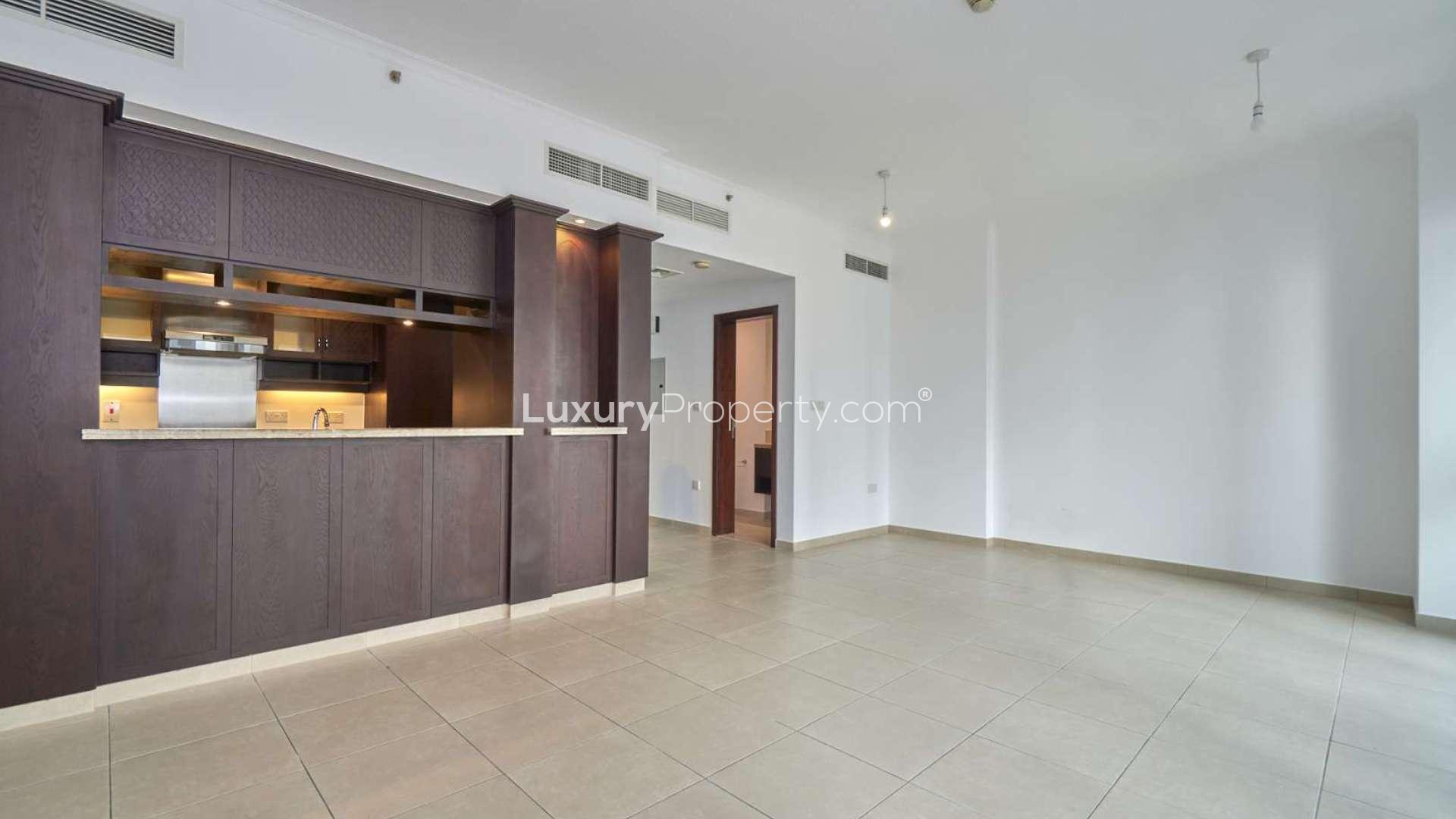 Empty living room with large windows in Downtown Dubai apartment, offering city views