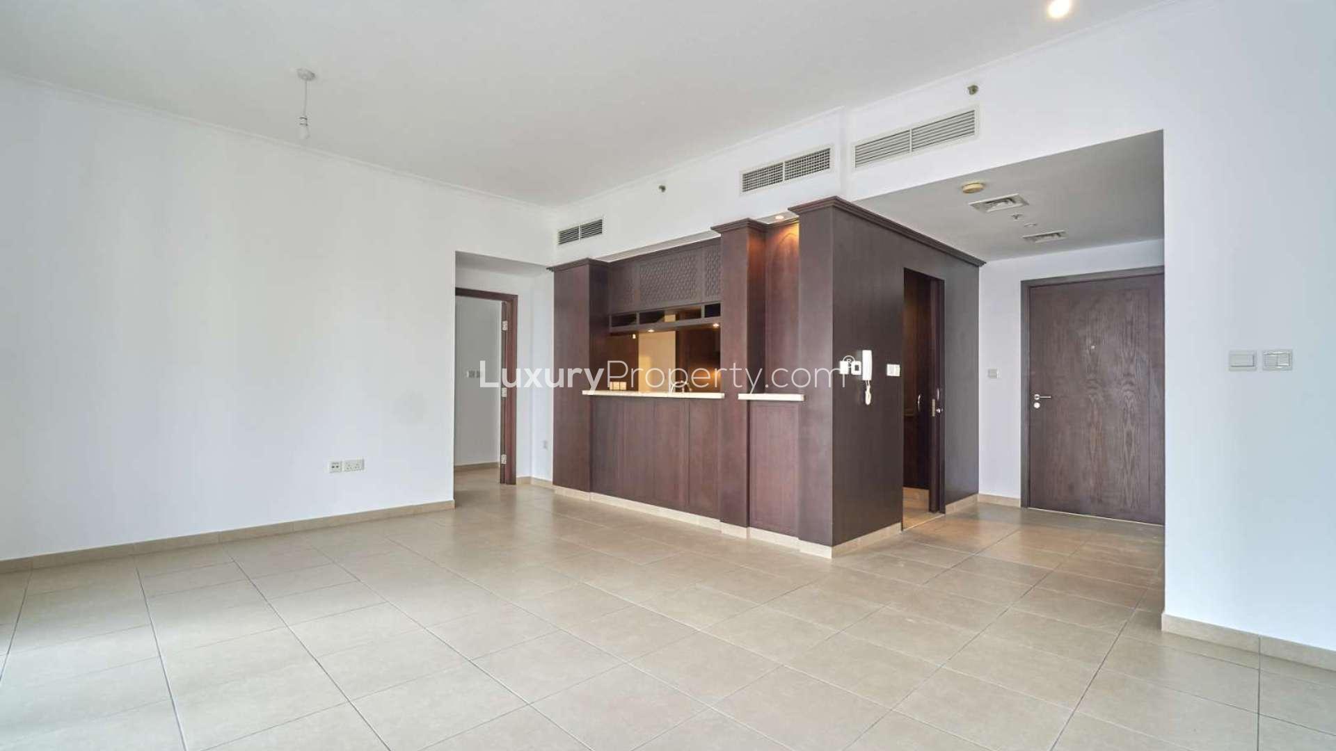 Empty living room with large windows and city views in Downtown Dubai apartment for rent