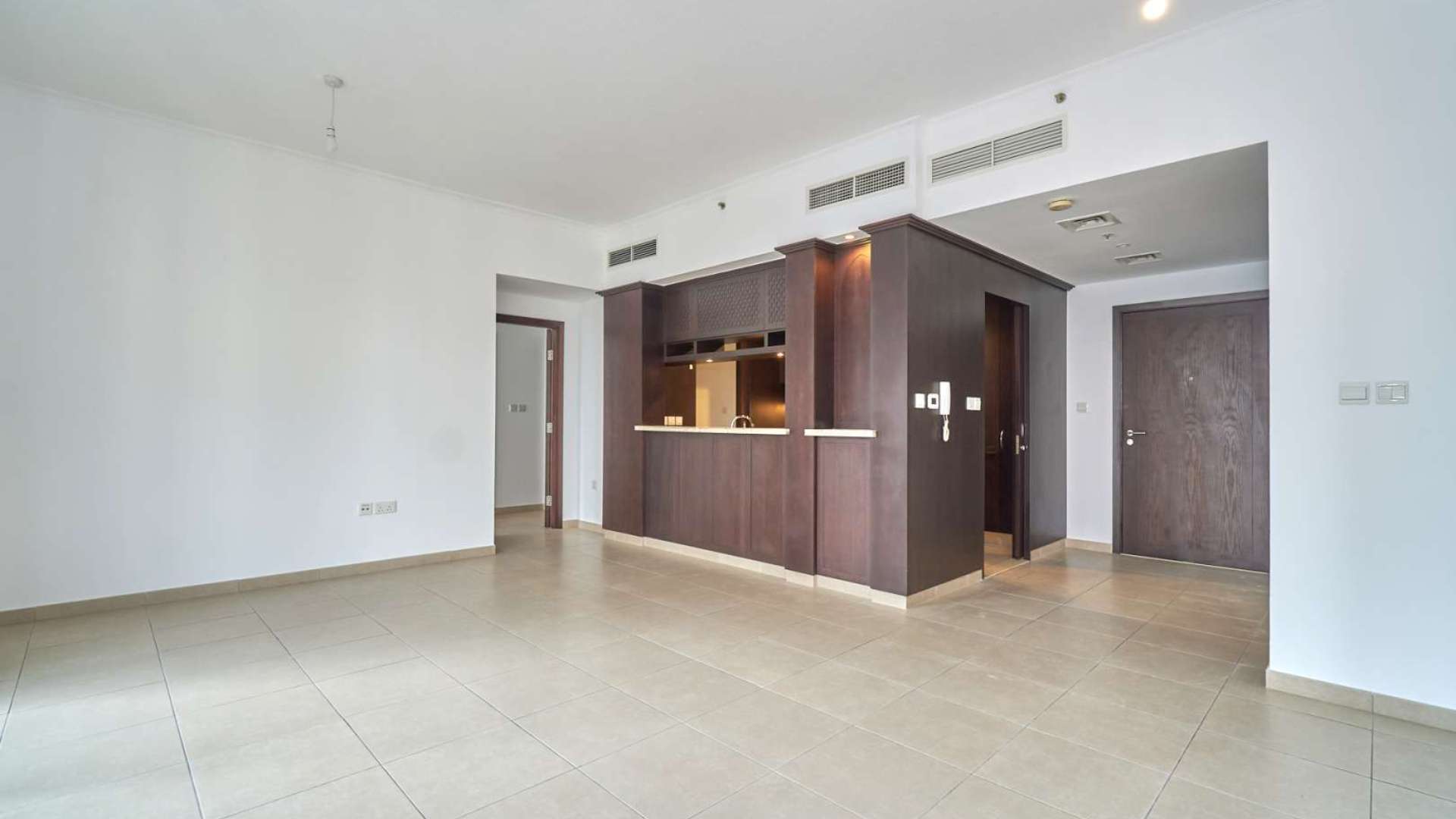 Empty living room with large windows and city views in Downtown Dubai apartment for rent