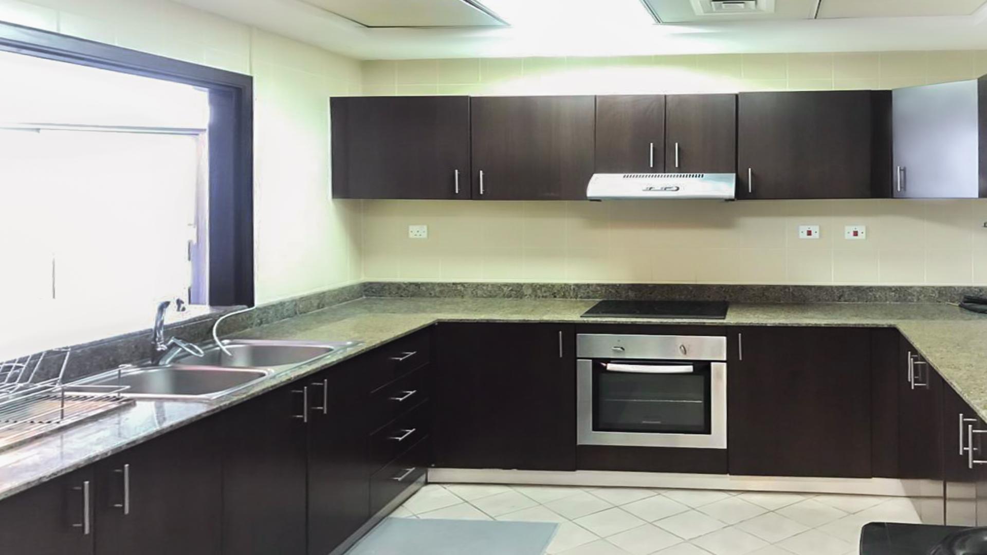 Furnished living room in Torch Tower apartment, Dubai Marina with large windows and city view