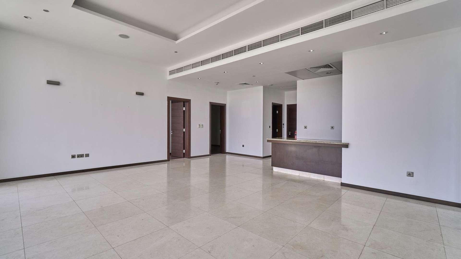 Spacious living area in Palm Jumeirah apartment with large windows and city view