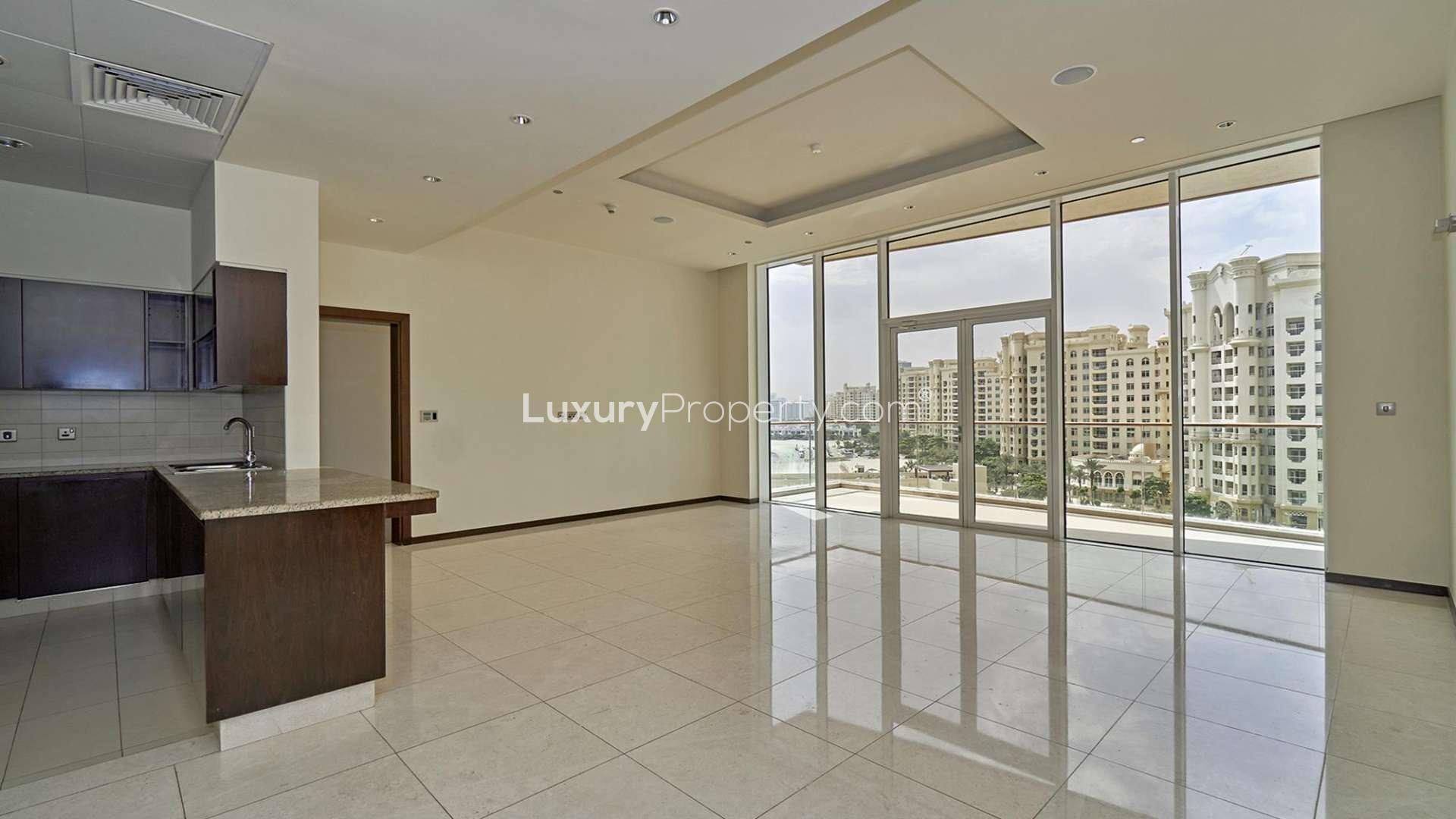 Spacious living room in Tiara Residences apartment, Palm Jumeirah, with large windows and balcony access