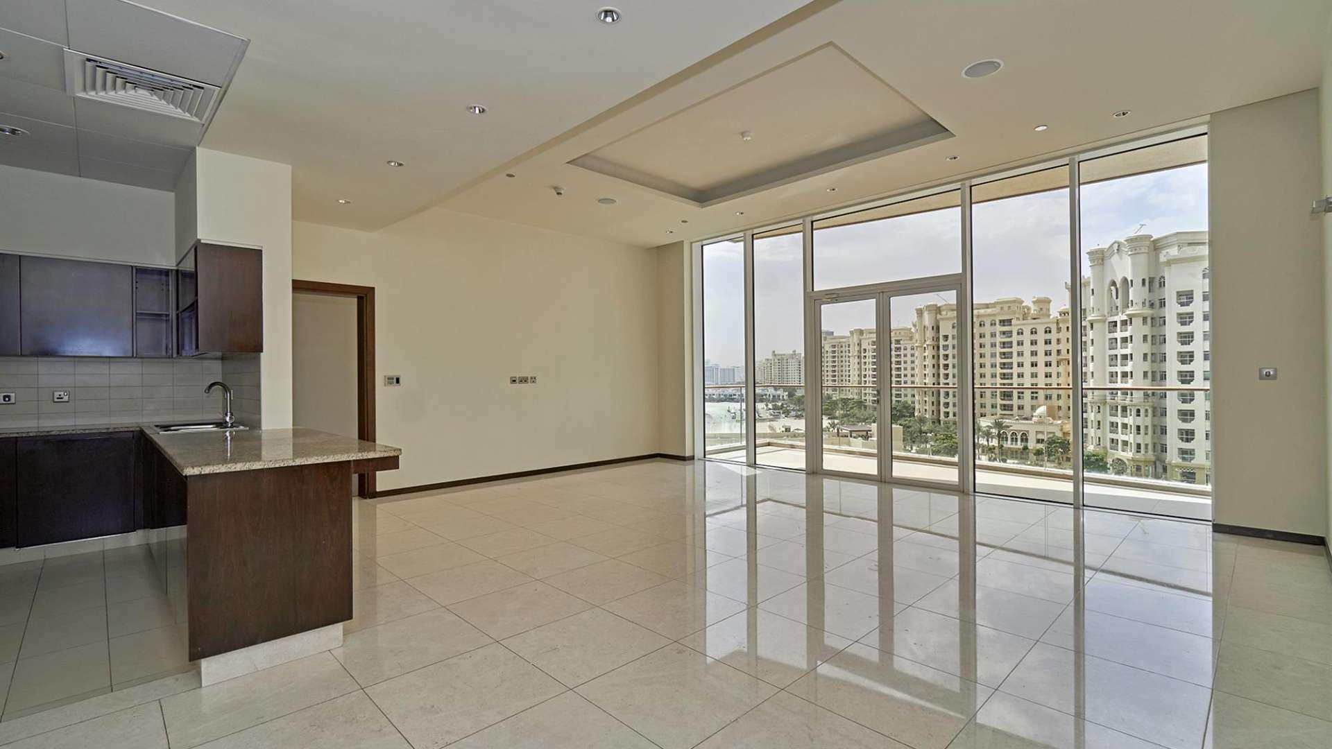 Spacious living room in Tiara Residences apartment, Palm Jumeirah, with large windows and balcony access