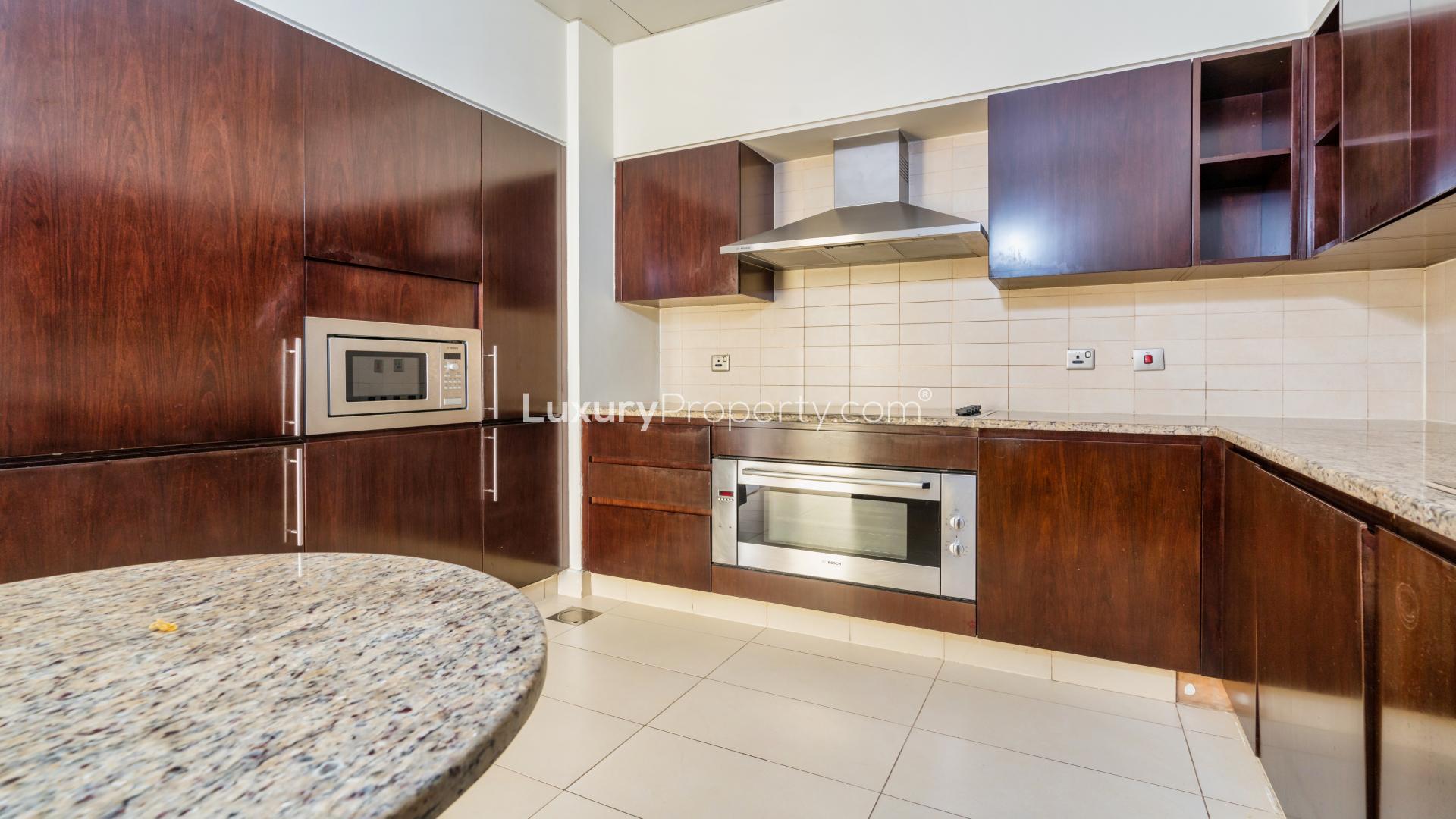 Modern kitchen in 3-bed apartment at Tiara Residences, Palm Jumeirah, with granite countertops