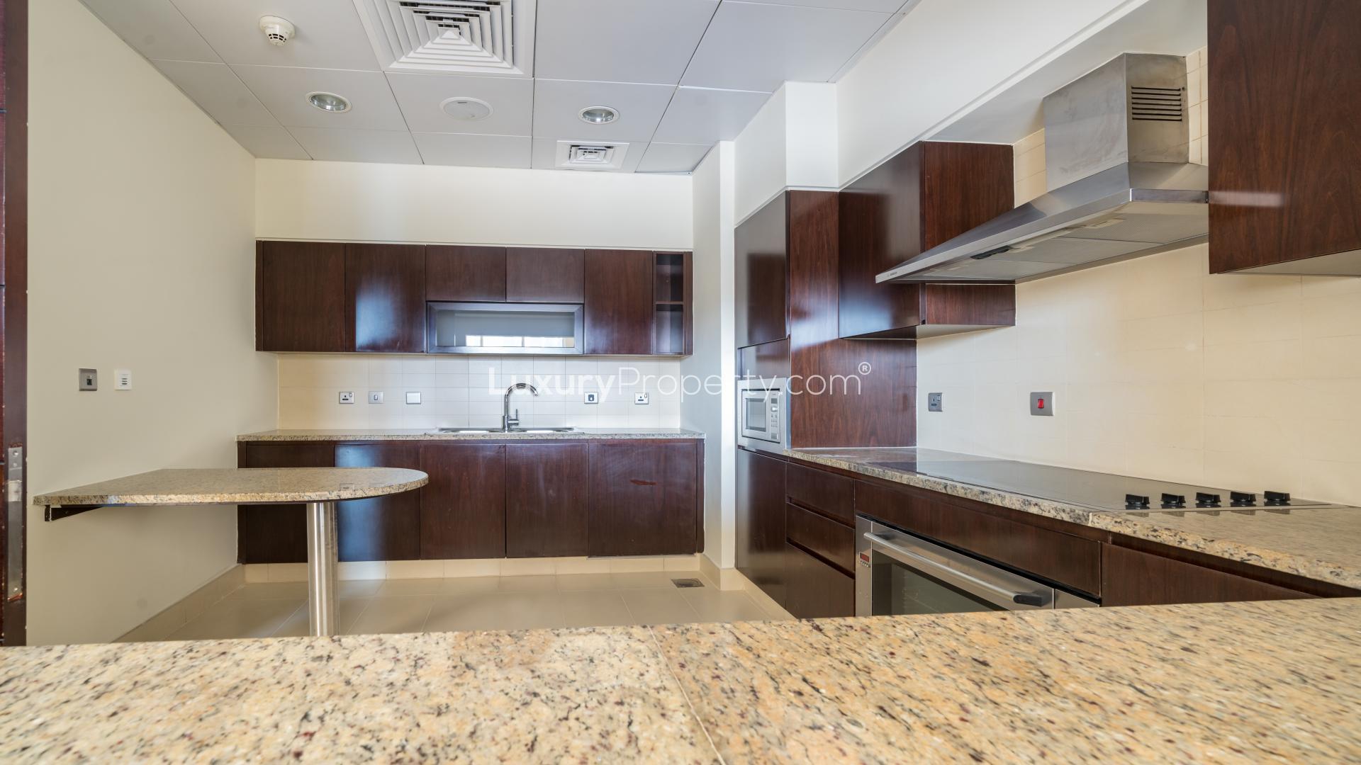 "Spacious balcony view from Tiara Residences apartment, overlooking Palm Jumeirah skyline and water.",Modern kitchen in vacant 3-bedroom apartment, Tiara Residences, Palm Jumeirah, with granite countertops