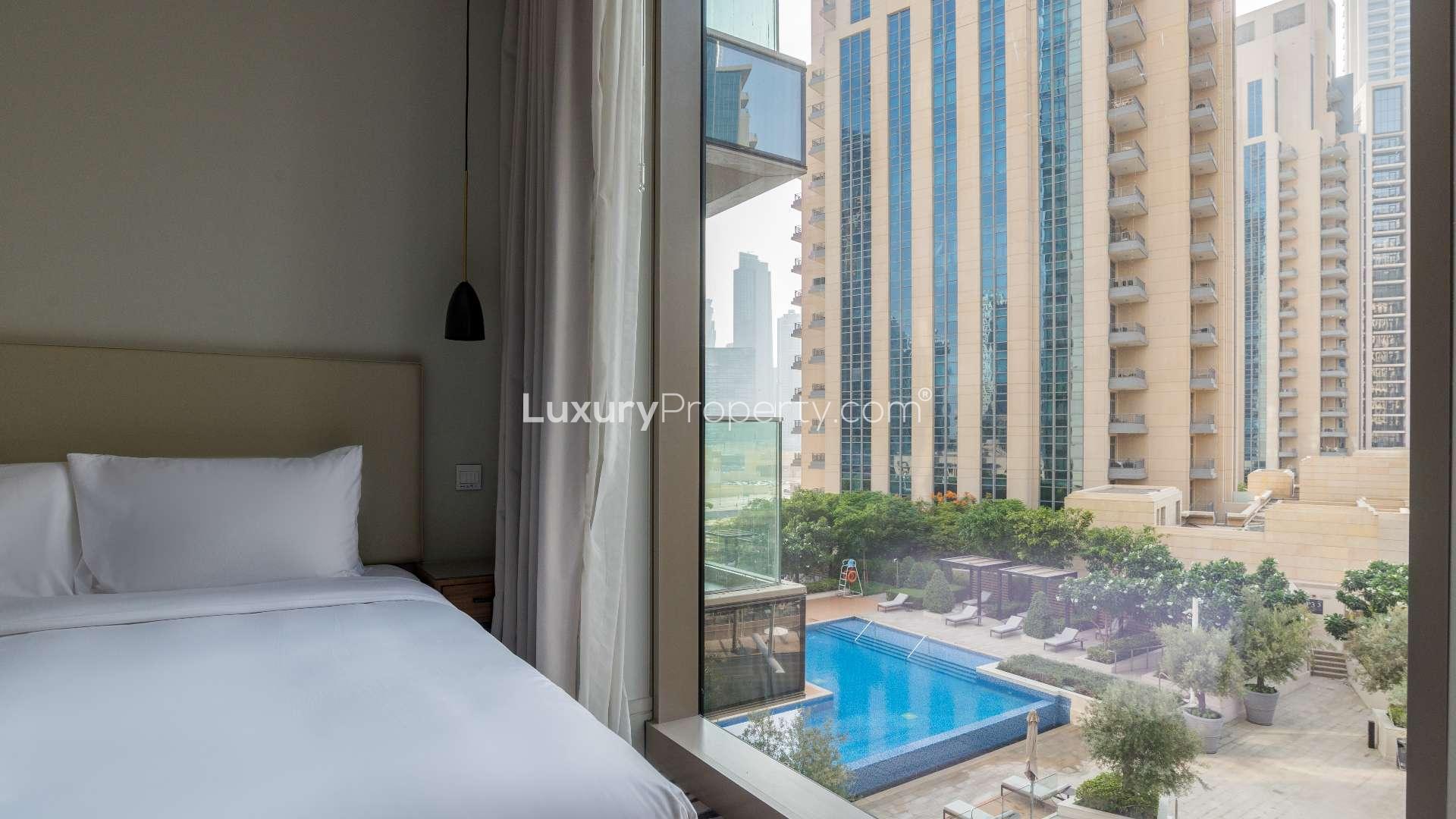 Modern kitchen in 3-bedroom apartment, Vida Residences, Downtown Dubai, with sleek design and bar seating