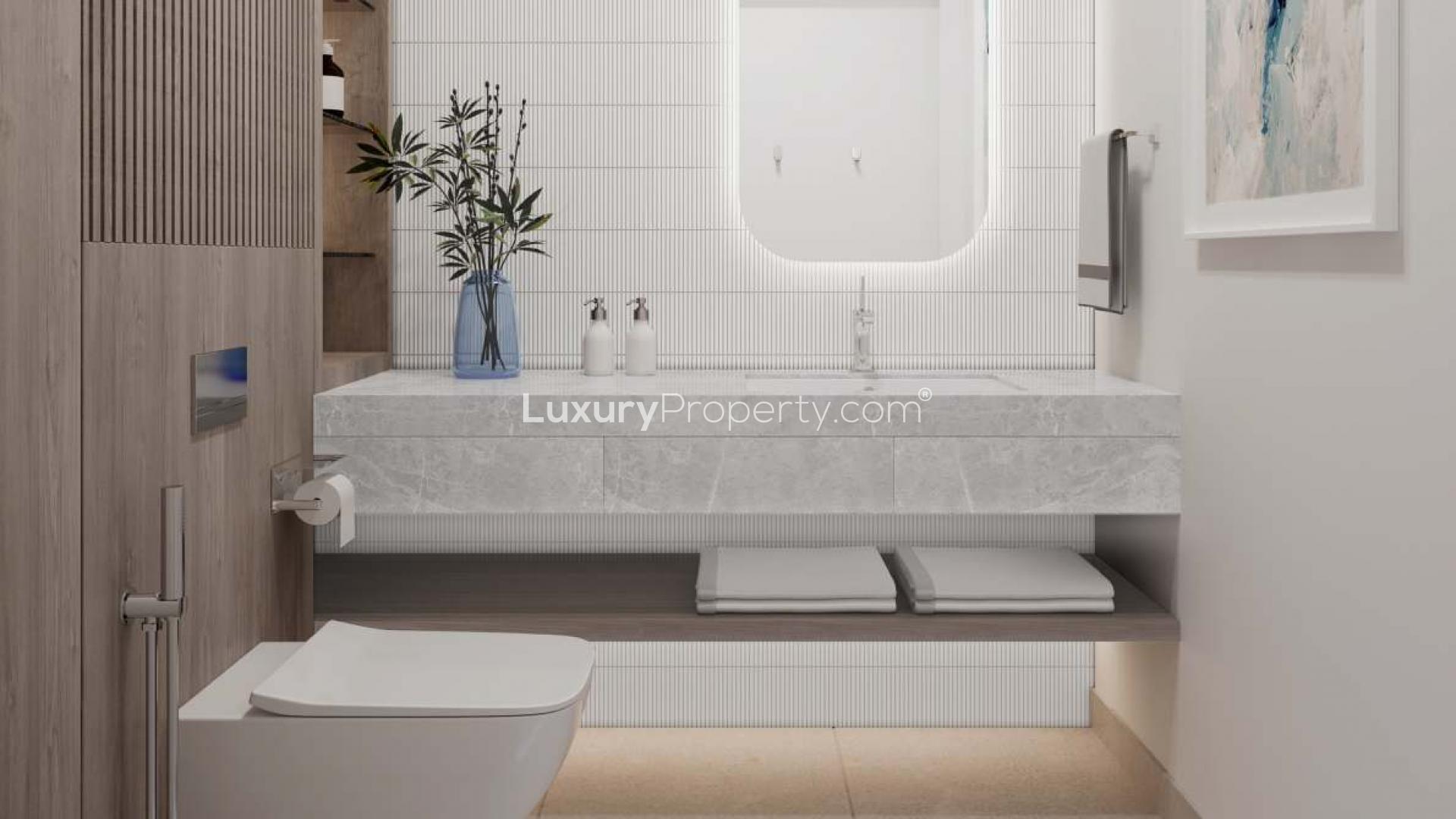 "Modern bedroom with balcony view in 3-bedroom Art Bay apartment, Al Jaddaf, for sale.",Modern bathroom in 3-bedroom Ellington Art Bay apartment, Al Jaddaf, featuring elegant decor