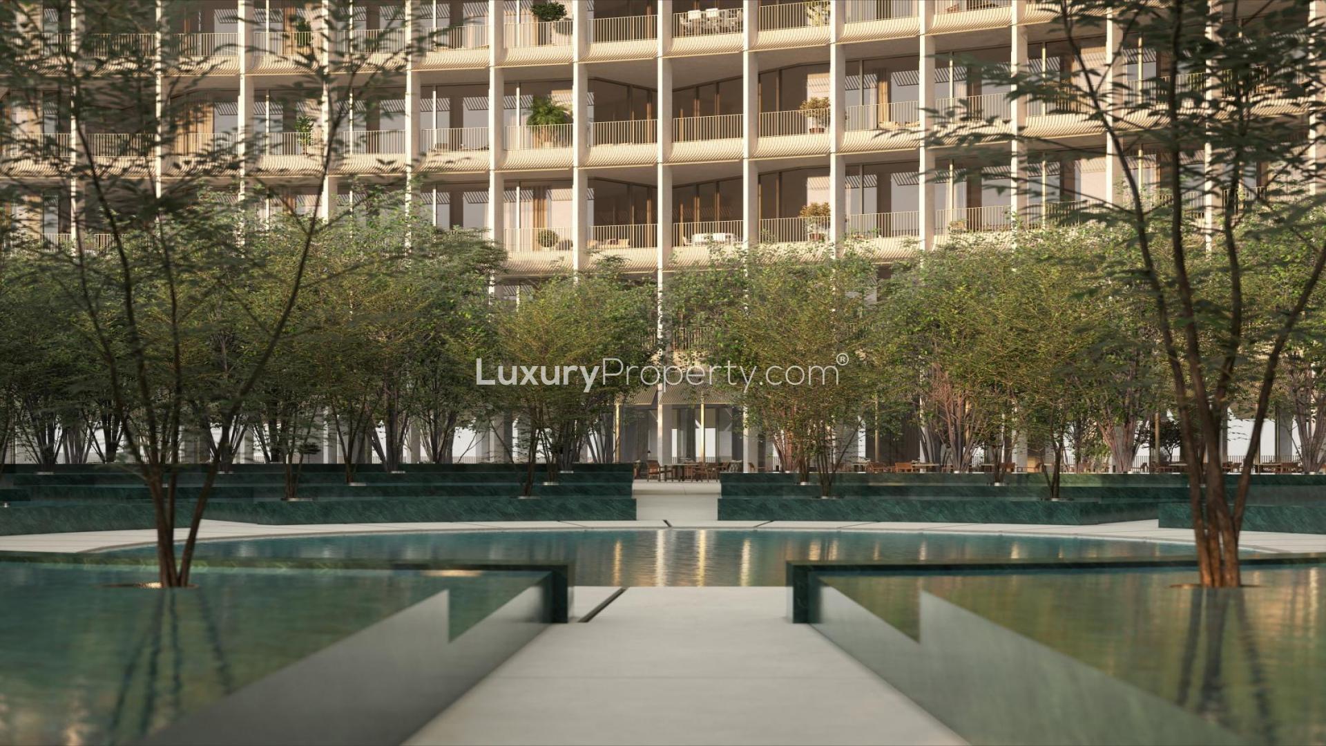 N/A,"Modern Four Seasons DIFC apartment exterior with lush landscaping and water features for sale.",Entrance of Four Seasons Residences DIFC with modern sculptures and water features