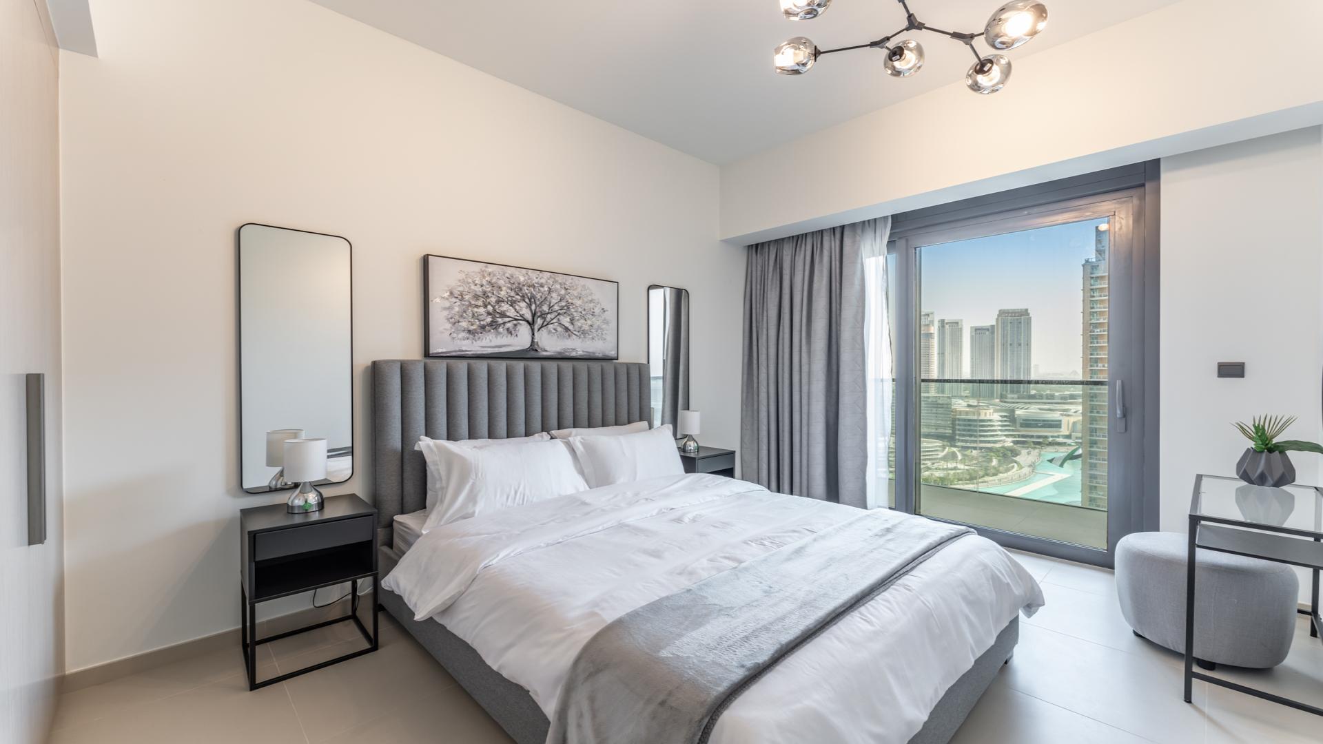 Bright bedroom in Act Towers apartment with city view, Downtown Dubai, Opera District