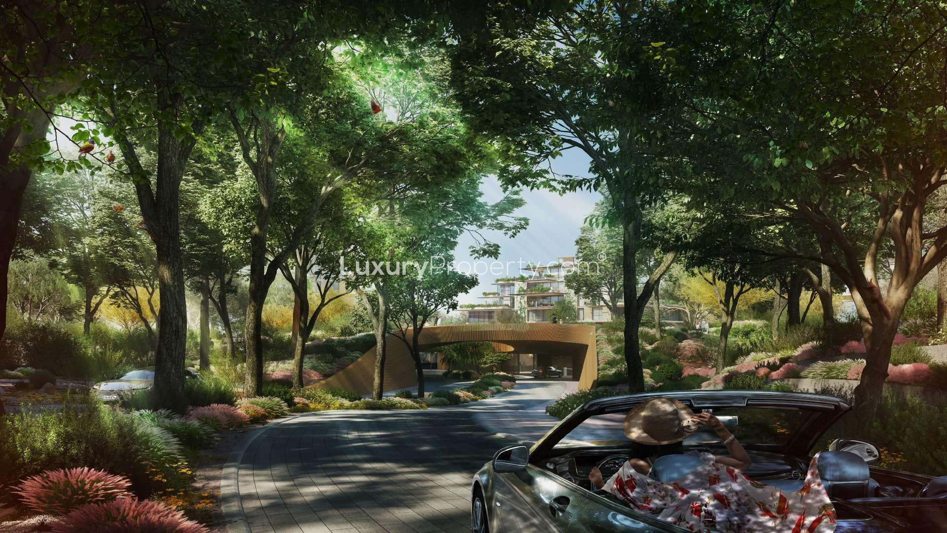 "Luxury Capria apartment exterior with forest view and pool in Ghaf Woods community.",Luxury forest-facing apartment entrance at Capria, Ghaf Woods; lush greenery and driveway view