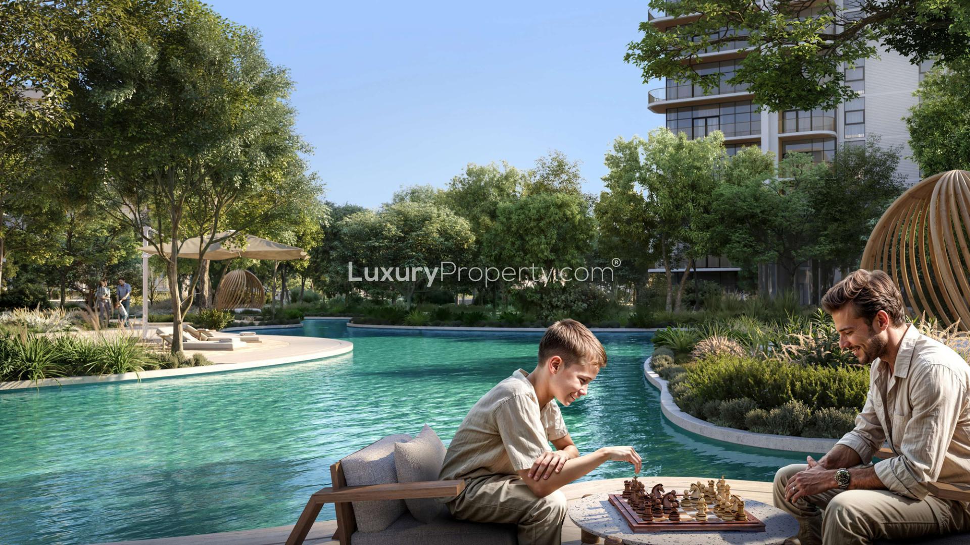 "Eco-friendly 3-bedroom duplex in Ghaf Woods Capria with lush greenery and modern design.",Outdoor chess game by pool in Ghaf Woods Capria community, surrounded by lush greenery