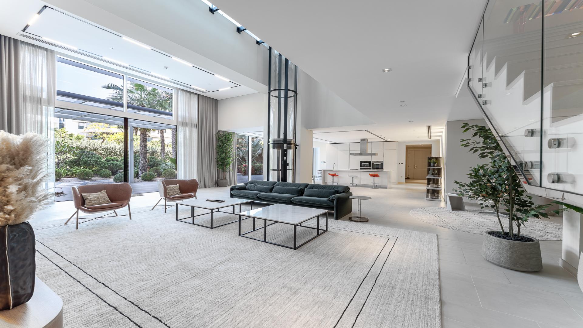 Luxurious living room in Seventh Heaven duplex, Al Barari, with modern decor and elevator