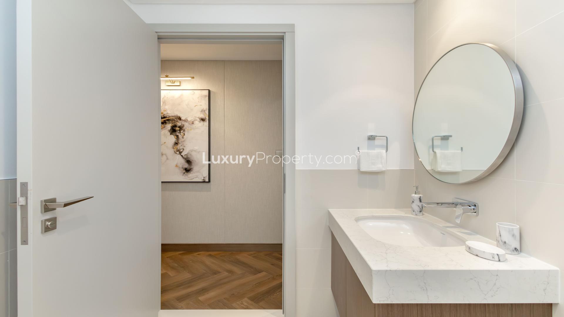 Luxurious bedroom in Beach Isle apartment, Emaar Beachfront, with modern decor and cozy ambiance