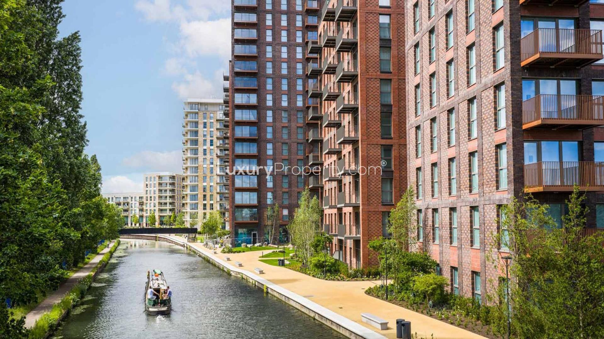 Modern living room in spacious Waterview House apartment, Grand Union, London, with balcony view