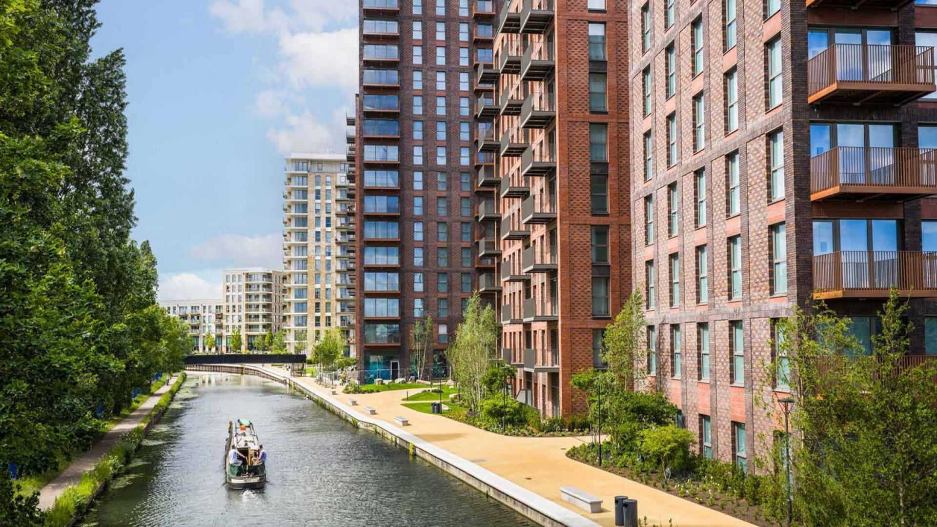 Modern living room in spacious Waterview House apartment, Grand Union, London, with balcony view