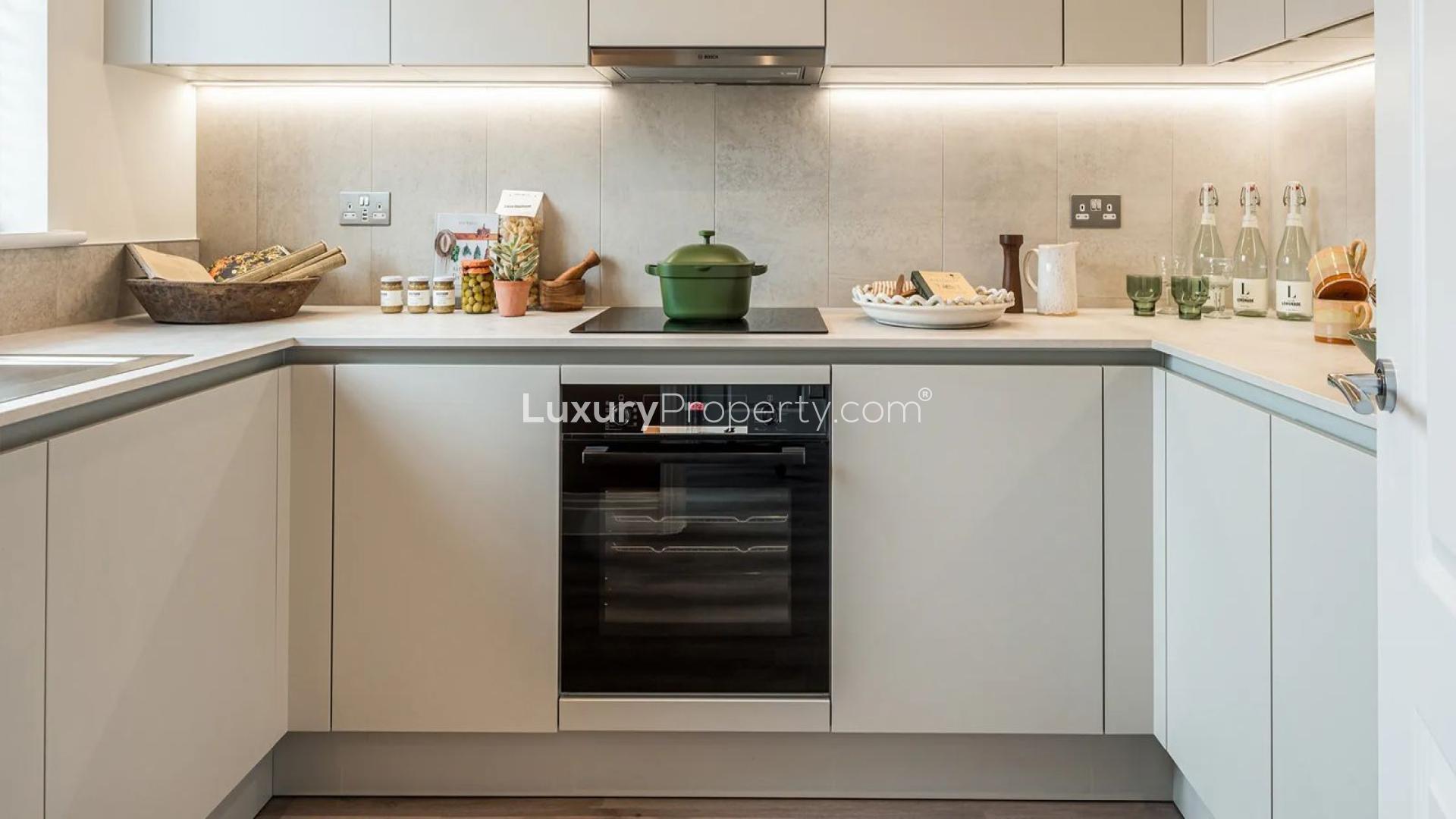 "Charming entryway in 3-bed apartment, Winterbrook Meadows, London, featuring modern decor and greenery.",Modern kitchen in 3-bed apartment, Winterbrook Meadows, London, The Springmead Collection
