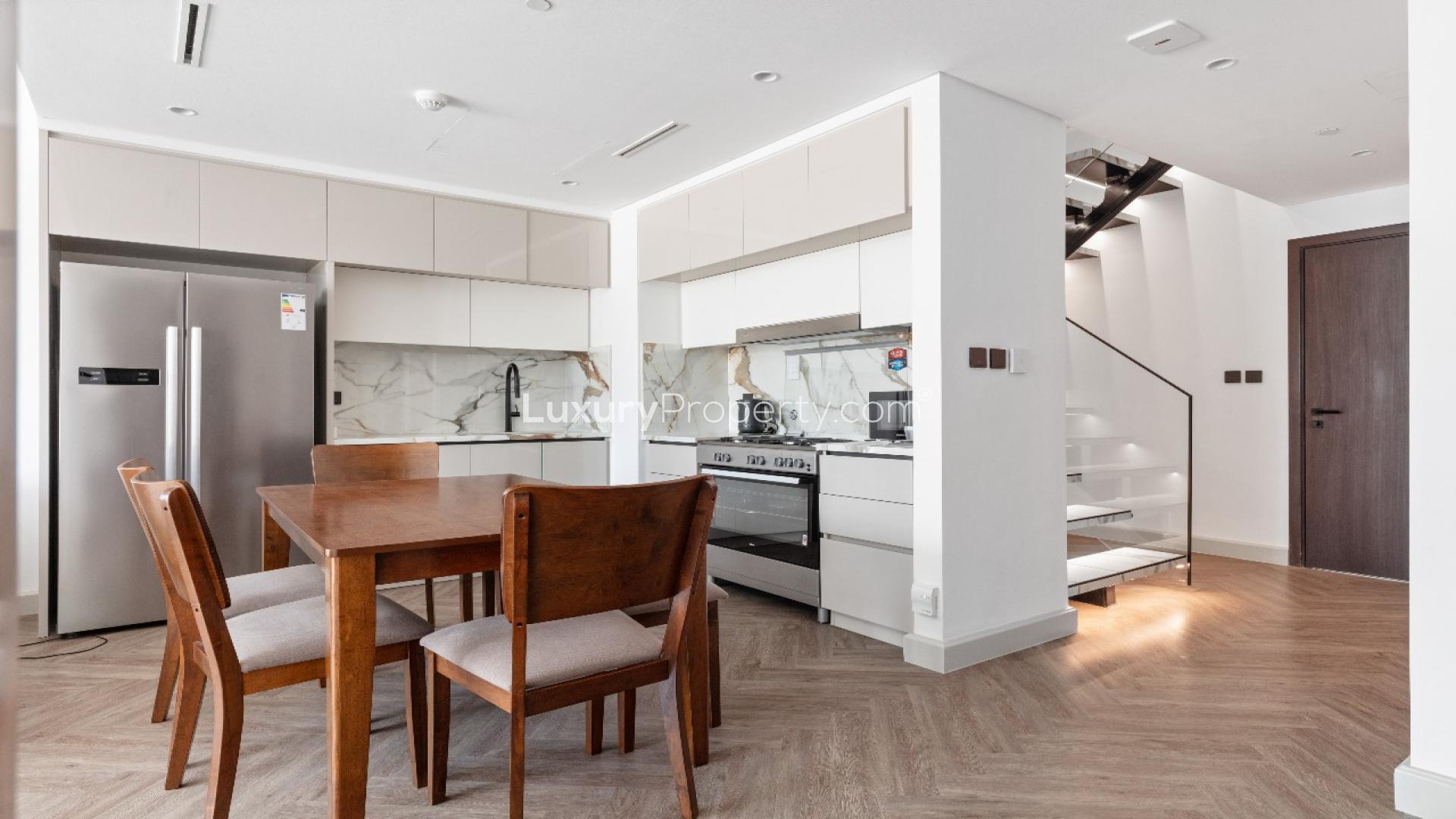 Spacious living room in Emaar Beachfront Marina Vista apartment with modern decor and balcony access