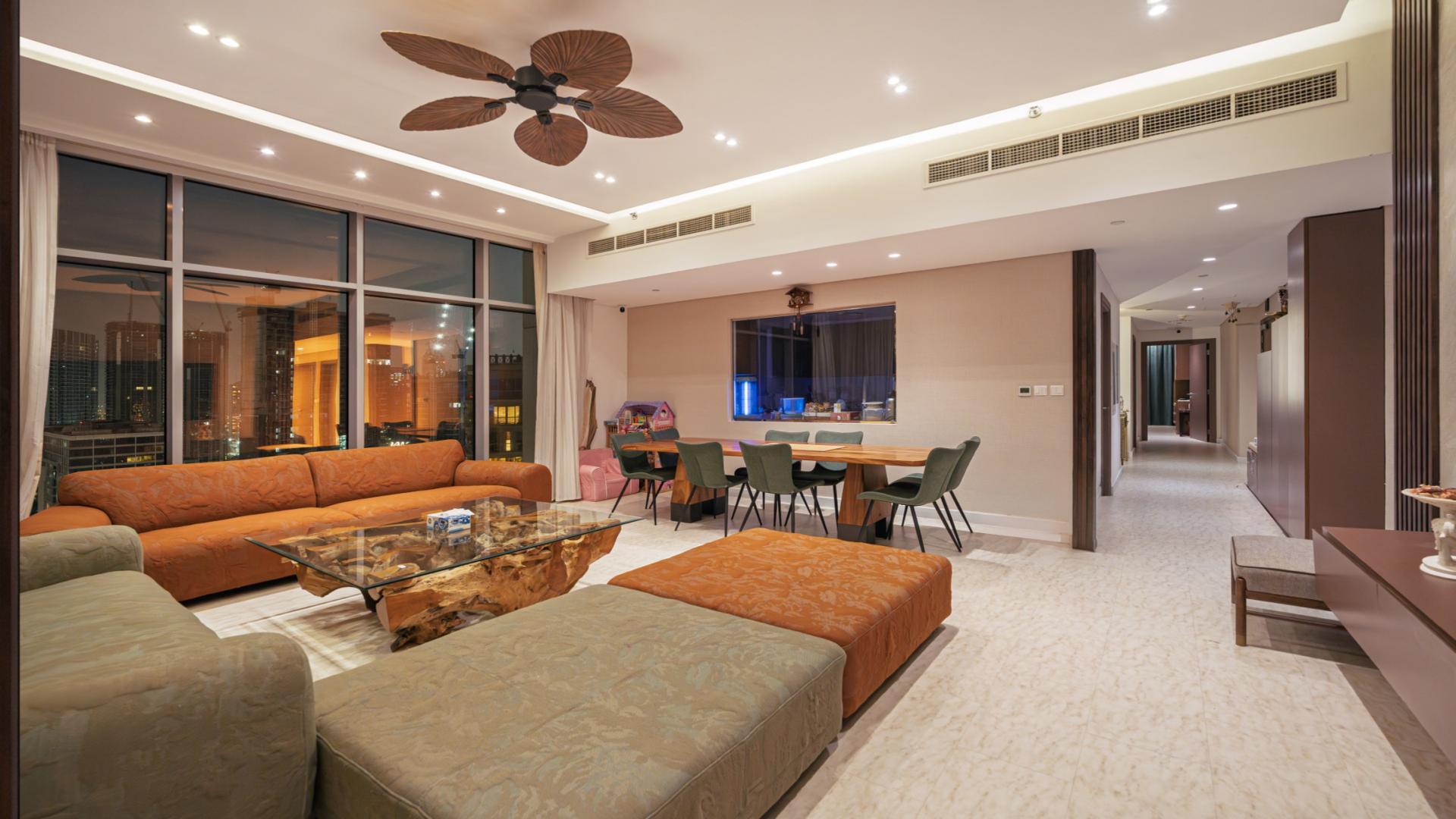 "Stunning balcony view from BLVD Crescent apartment in Downtown, 3-bedroom, 4-bathroom for sale.",Luxurious living room in Downtown BLVD Crescent apartment for sale, featuring modern decor