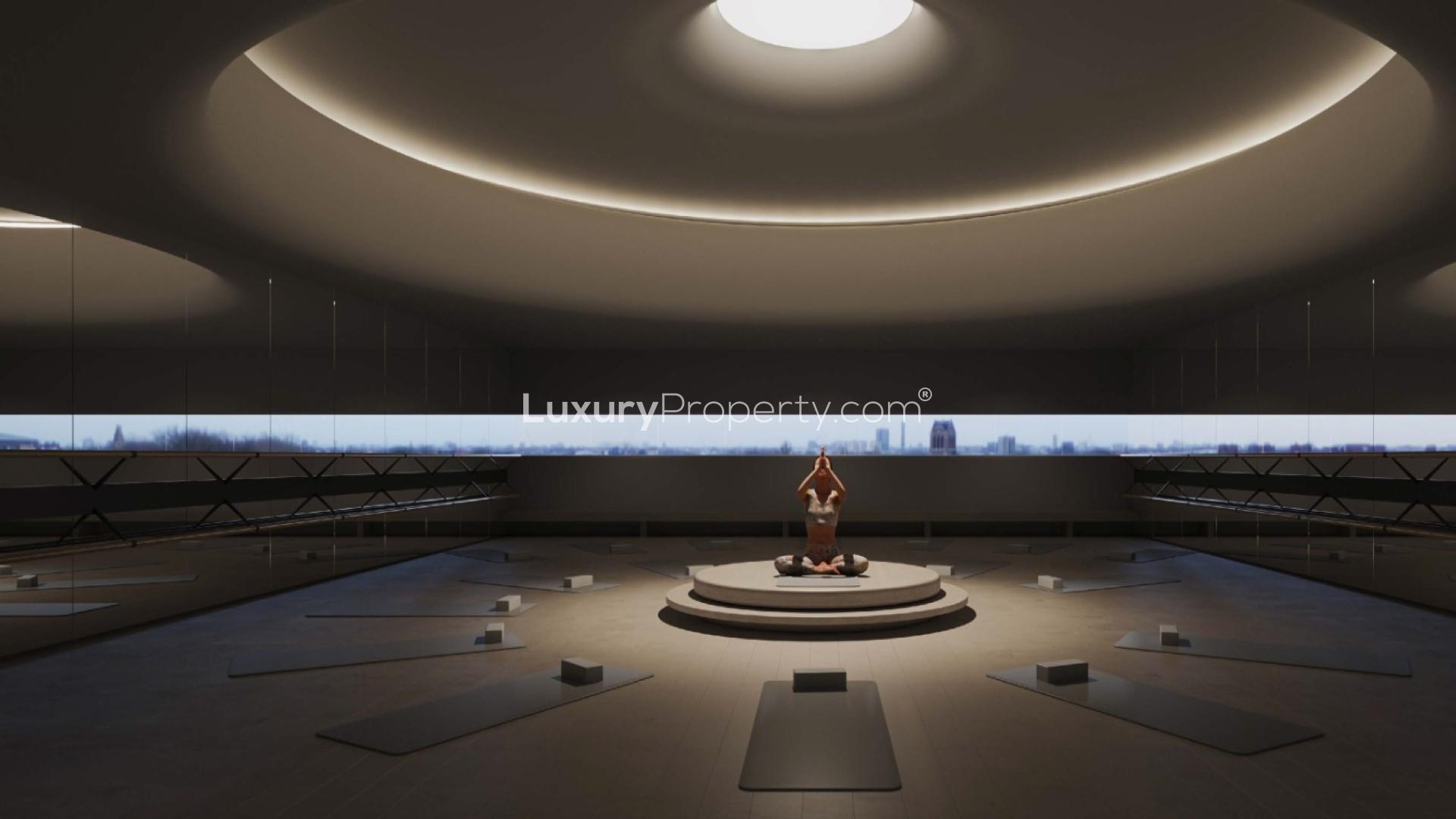 Modern architecture at Akala Hotel and Residences, DIFC, featuring curved glass and reflections