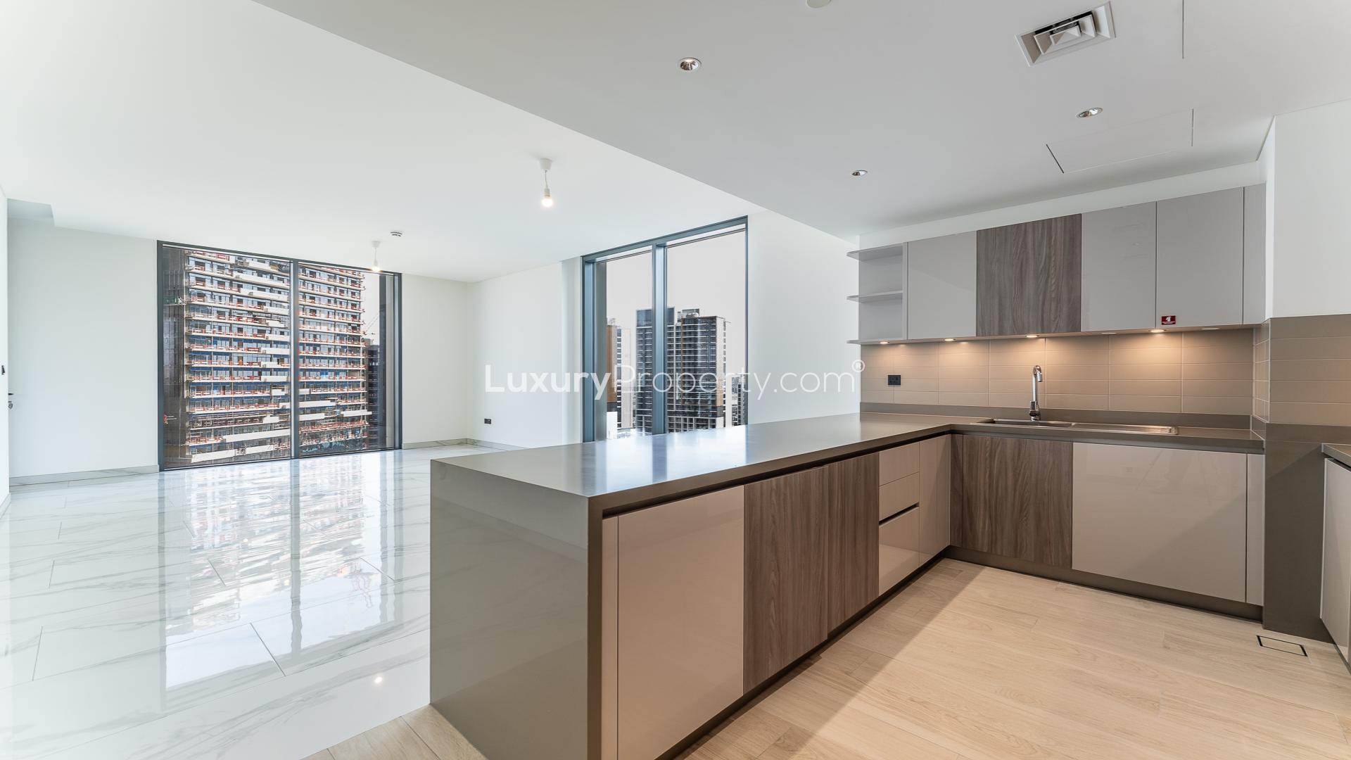 Modern kitchen and living area in Sobha Hartland Crest Grande apartment for sale