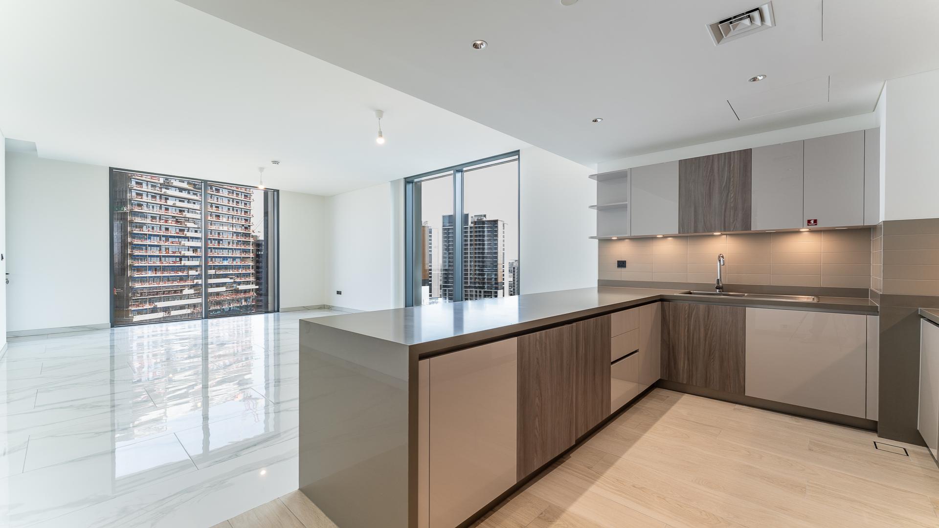 Modern kitchen and living area in Sobha Hartland Crest Grande apartment for sale