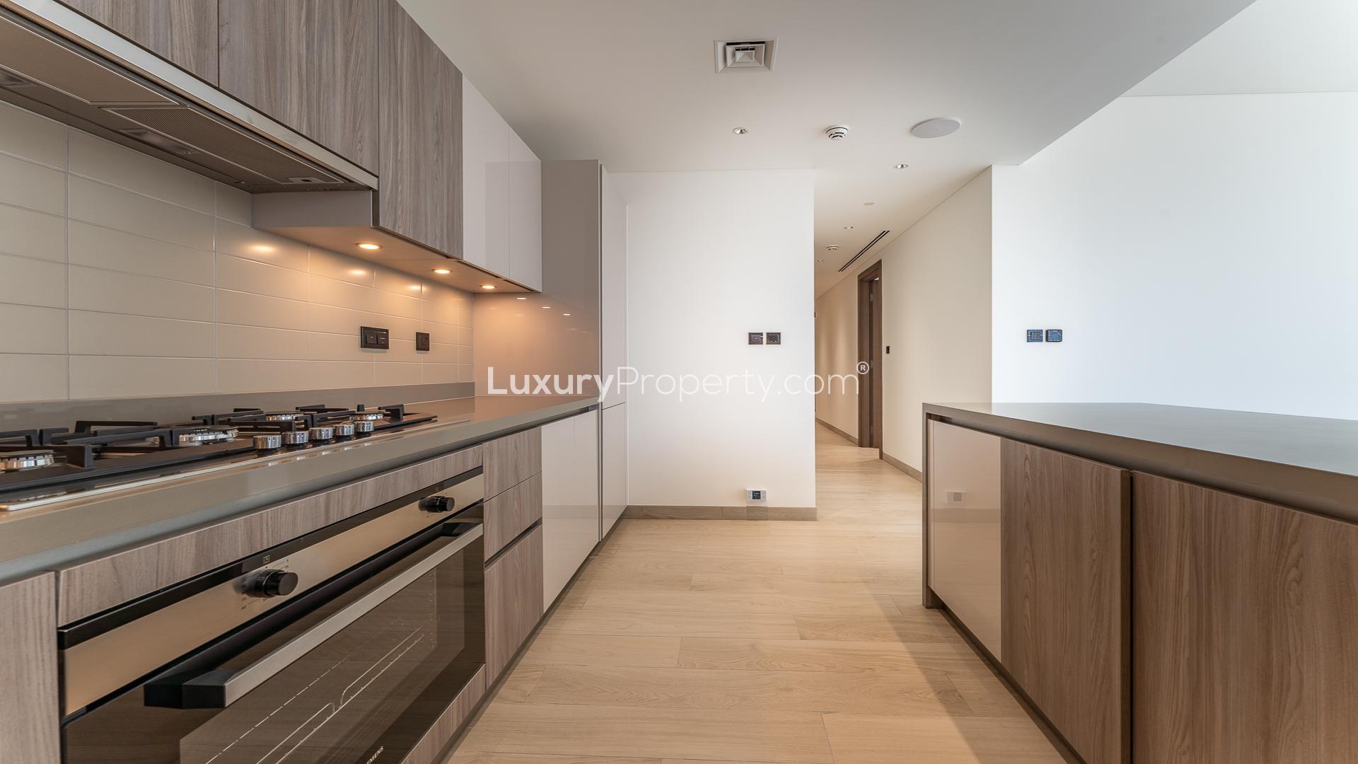 Modern kitchen and living area in Sobha Hartland Crest Grande apartment for sale