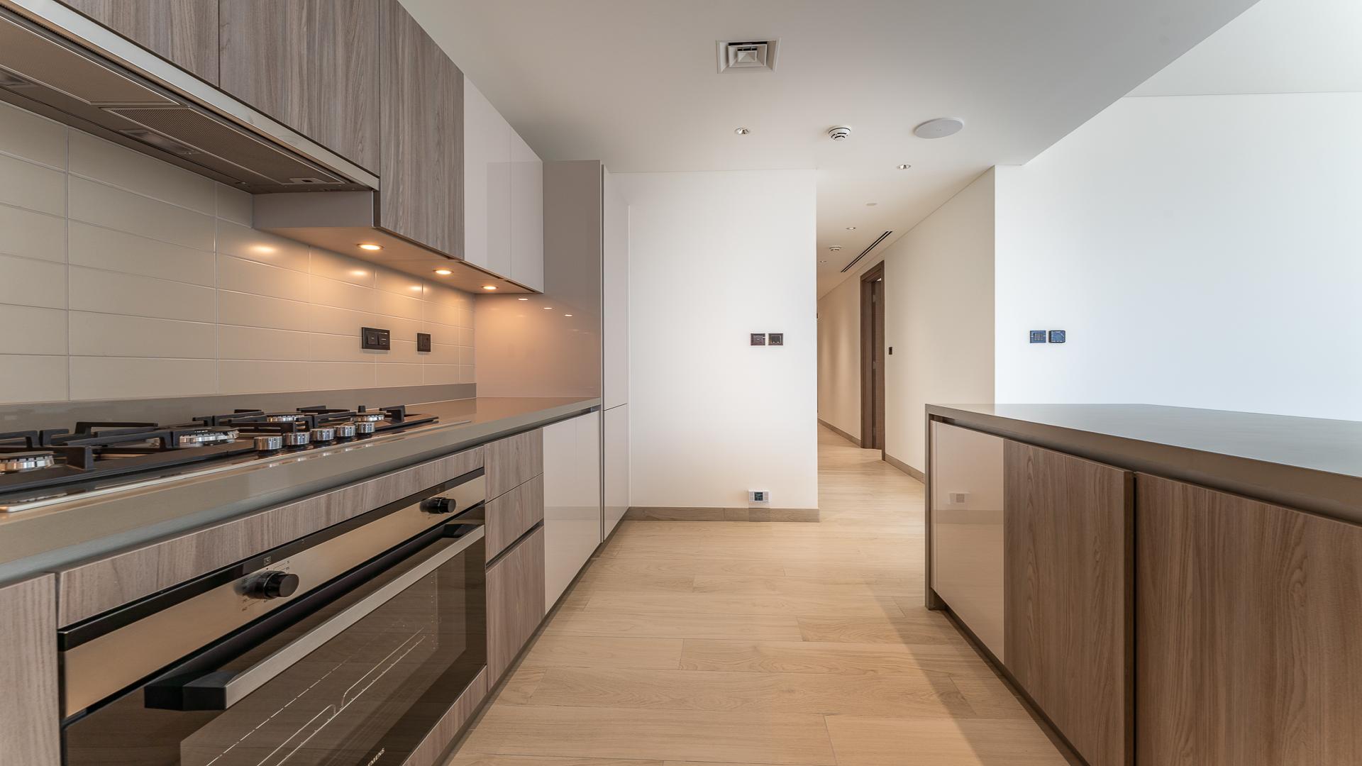 Modern kitchen and living area in Sobha Hartland Crest Grande apartment for sale