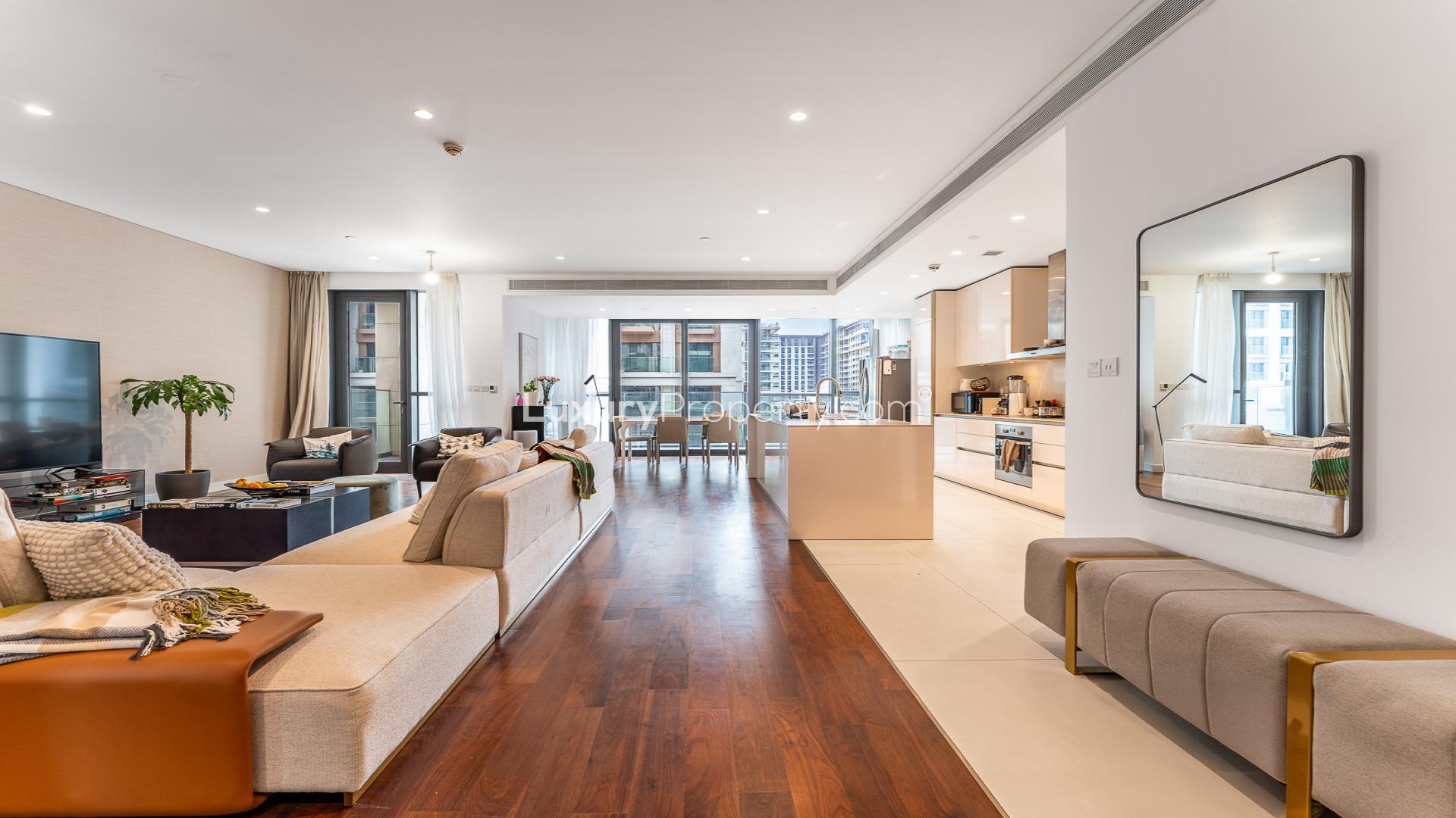 Modern open-plan living area in City Walk apartment, featuring sleek kitchen and dining space