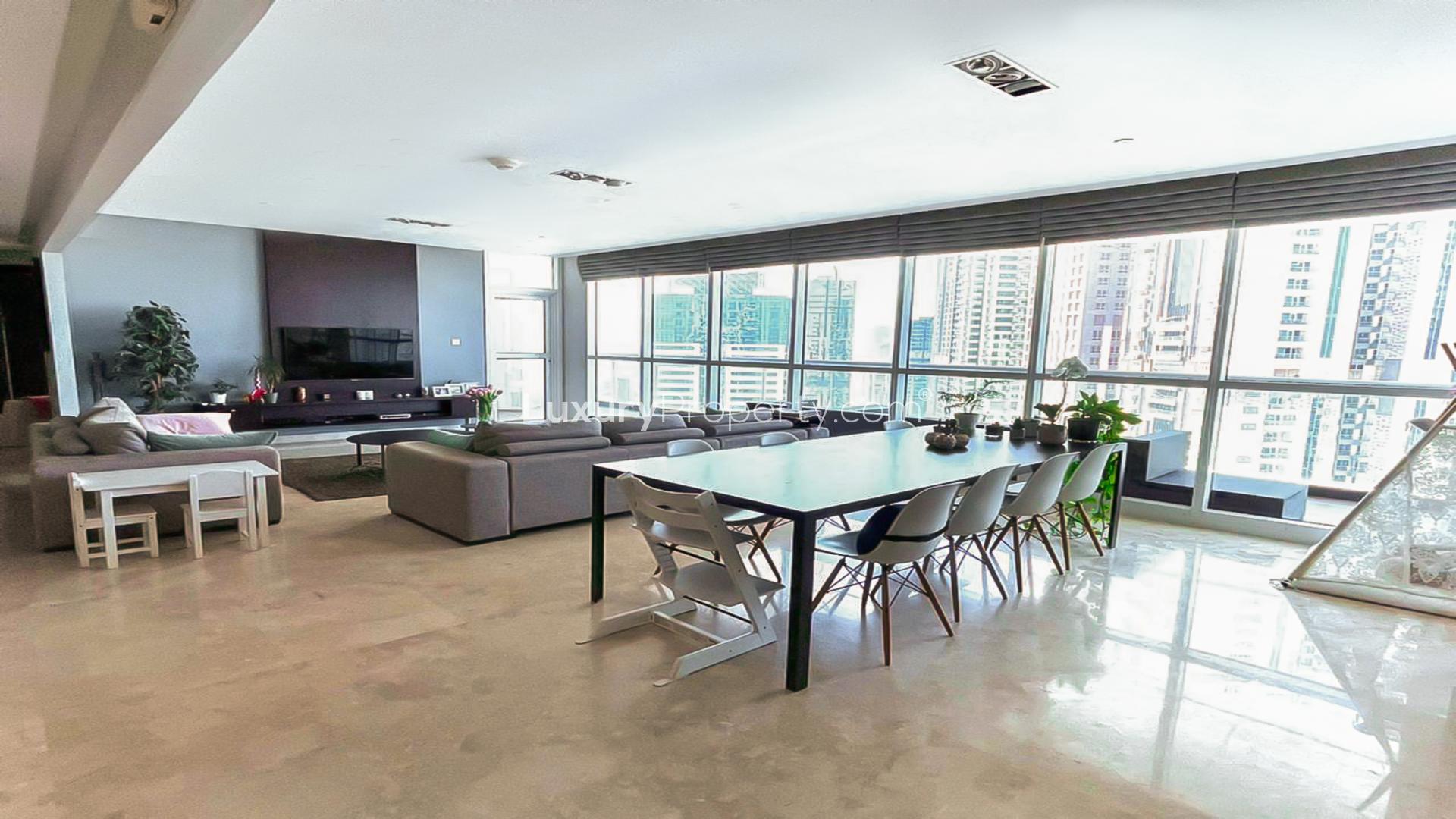 Luxurious Dubai Marina apartment living room with panoramic windows and modern decor