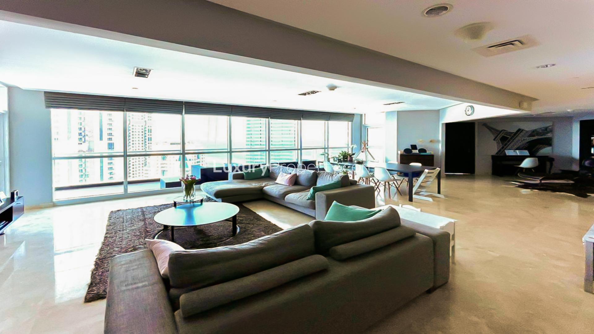Spacious living area in Dubai Marina apartment with panoramic sea views and modern furnishings