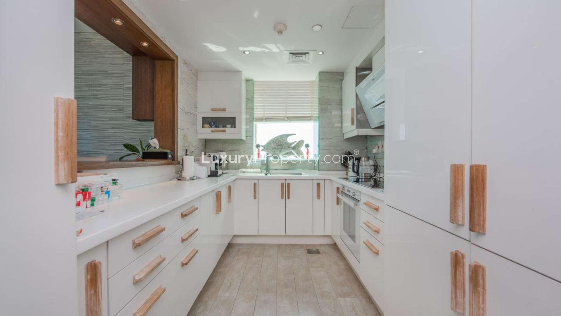 "Modern living room in fully upgraded JBR apartment, Al Bateen Residences, sea view.",Modern kitchen in fully upgraded JBR apartment, Al Bateen Residences, sea view included