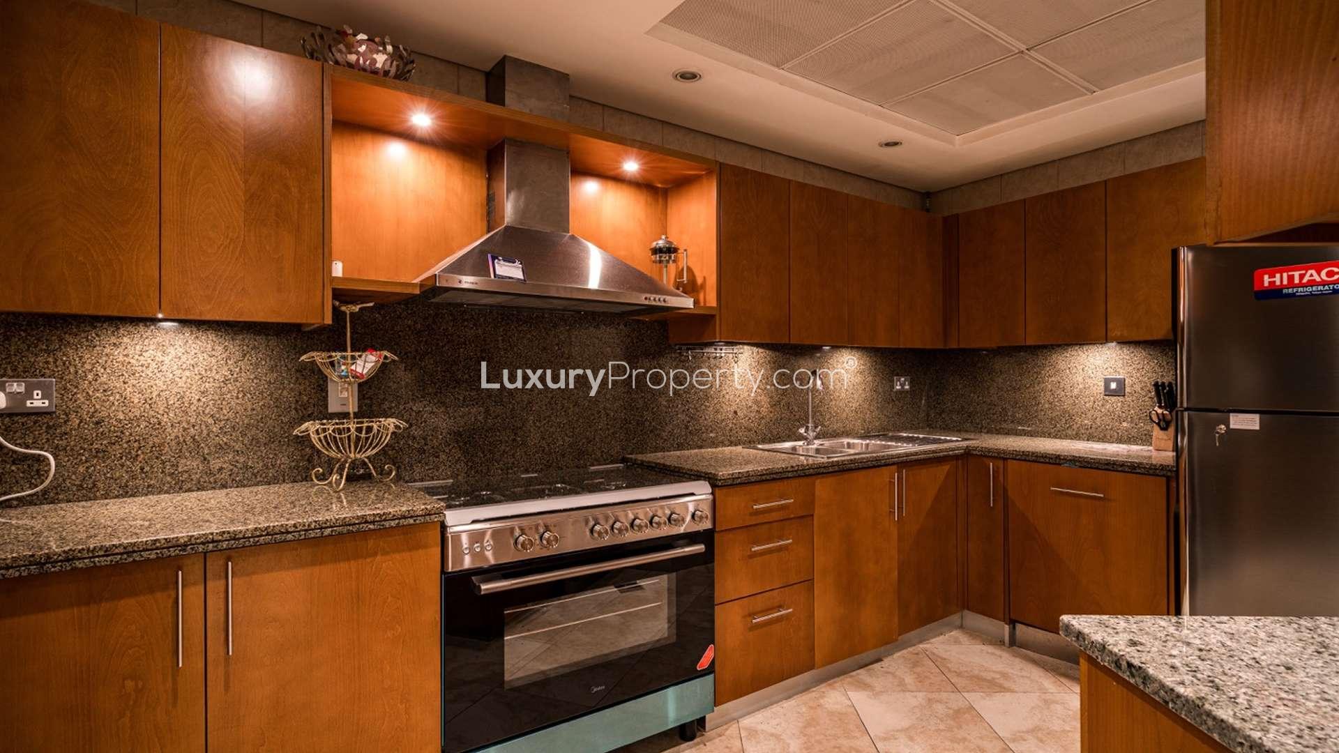 Modern kitchen in three-bedroom apartment, Al Fattan Marine Towers, JBR, granite countertops, wood cabinets