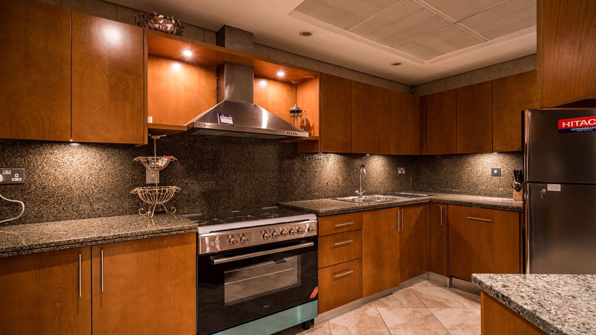 Modern kitchen in three-bedroom apartment, Al Fattan Marine Towers, JBR, granite countertops, wood cabinets