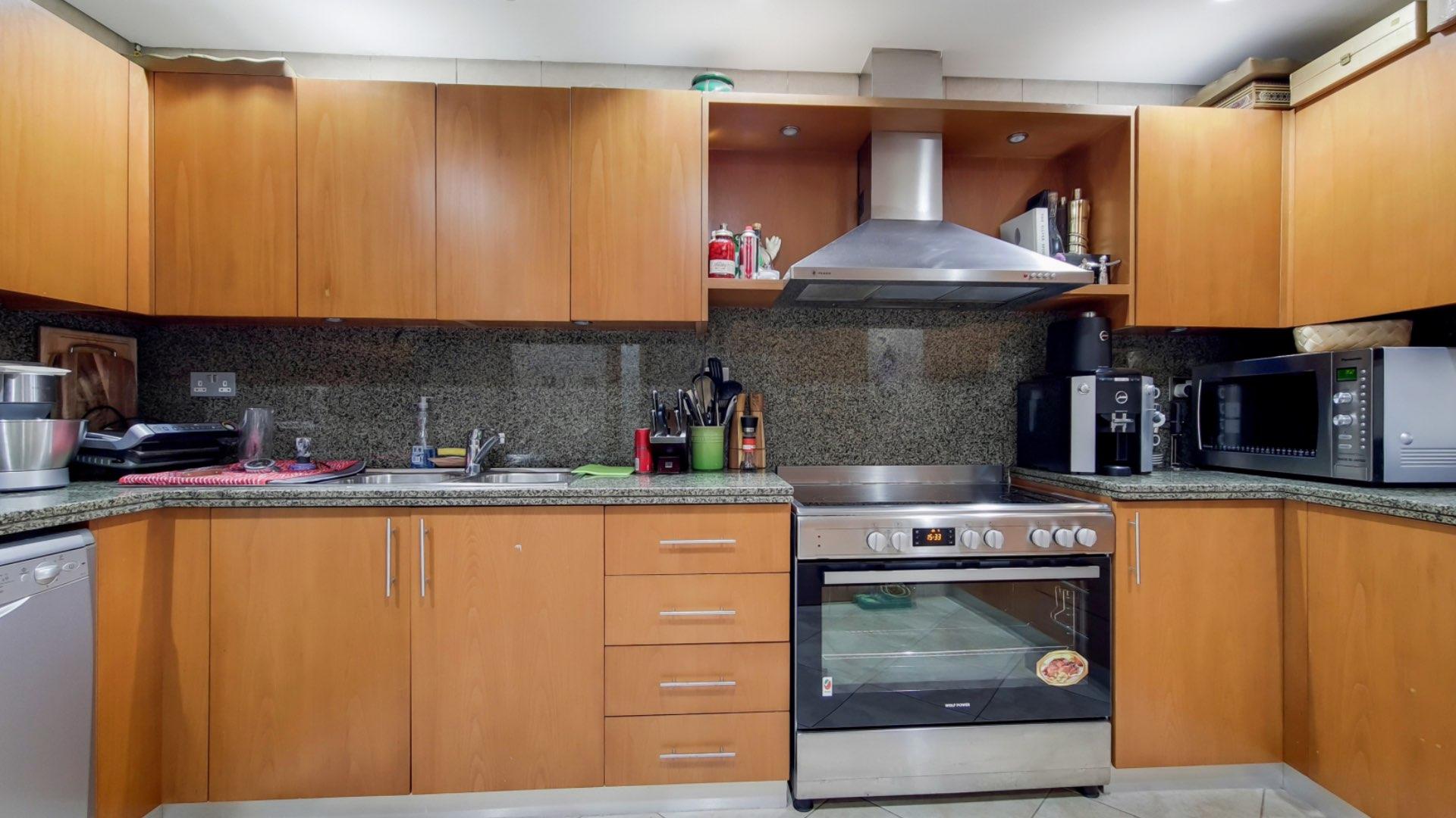 Dining and living area in JBR apartment with large windows and partial sea view