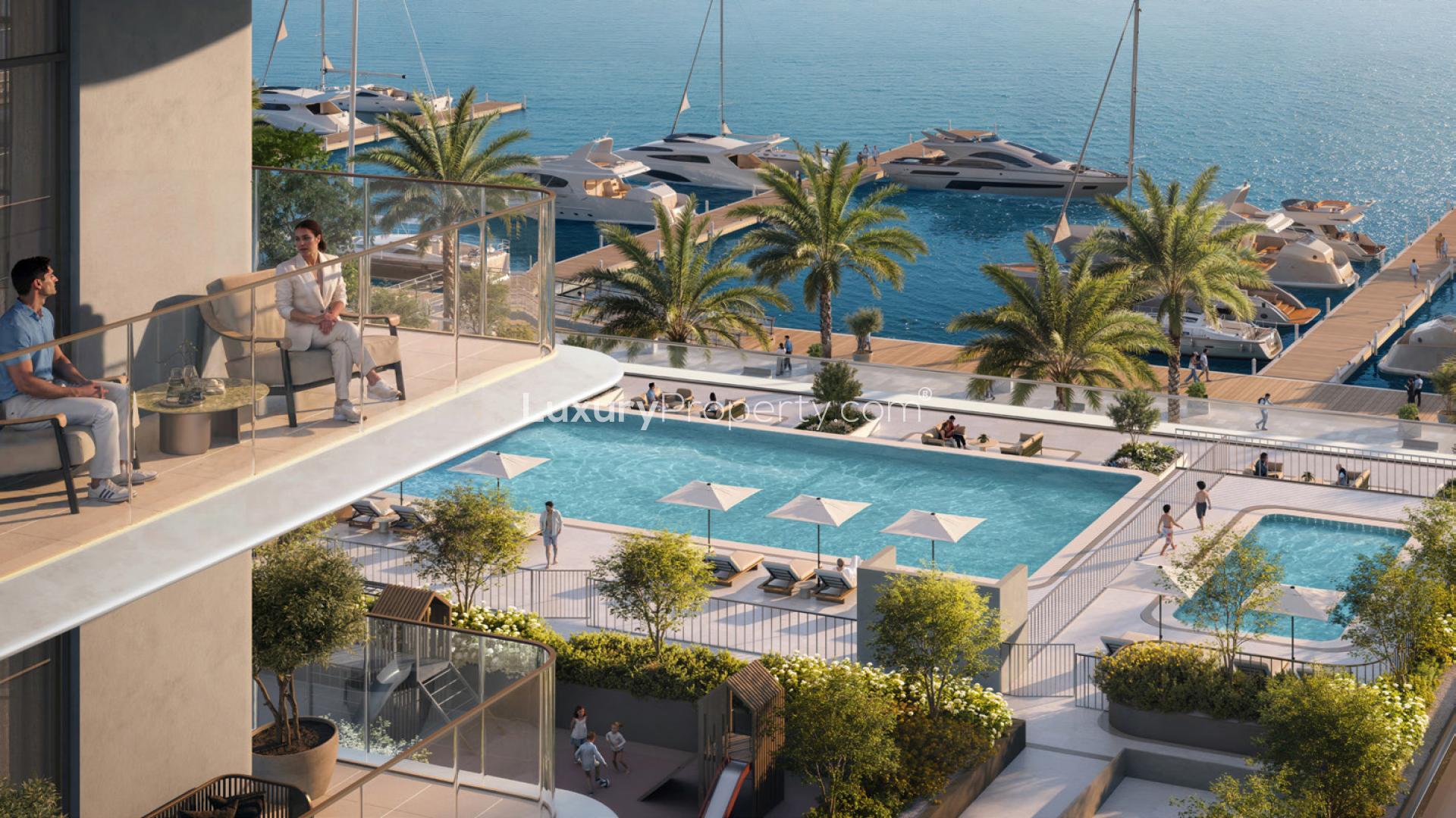 "Stunning waterfront view from Pier Point 1 apartment, Rashid Yachts & Marina, for sale.",Waterfront apartment balcony view with pool and marina at Rashid Yachts & Marina
