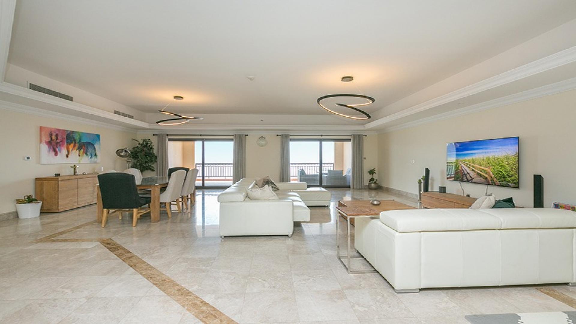 Luxurious living room in Palm Jumeirah apartment with modern decor and stunning sea views.