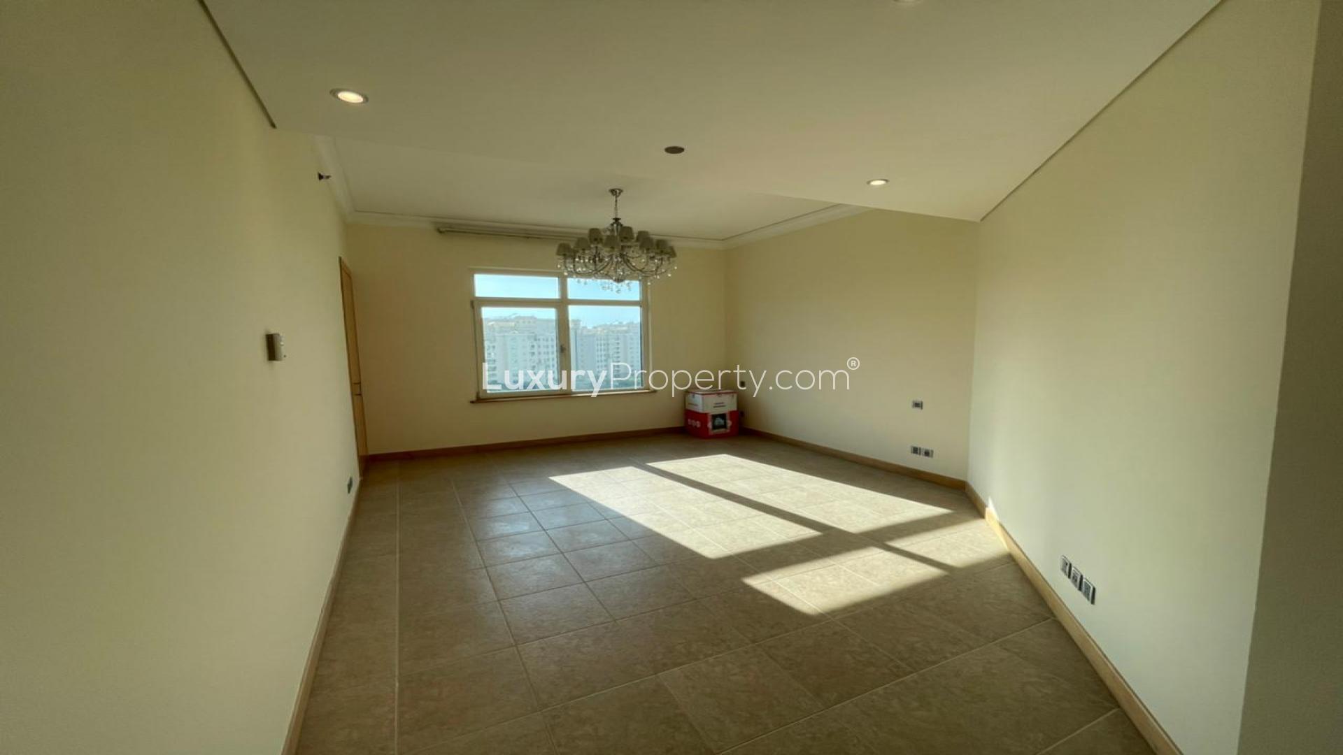 Empty room with tiled floor and window view in Shoreline Apartments, Palm Jumeirah