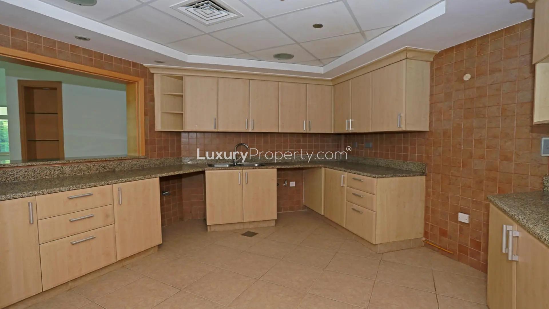 Empty living room in Shoreline Apartments, Palm Jumeirah, with large windows and tile flooring