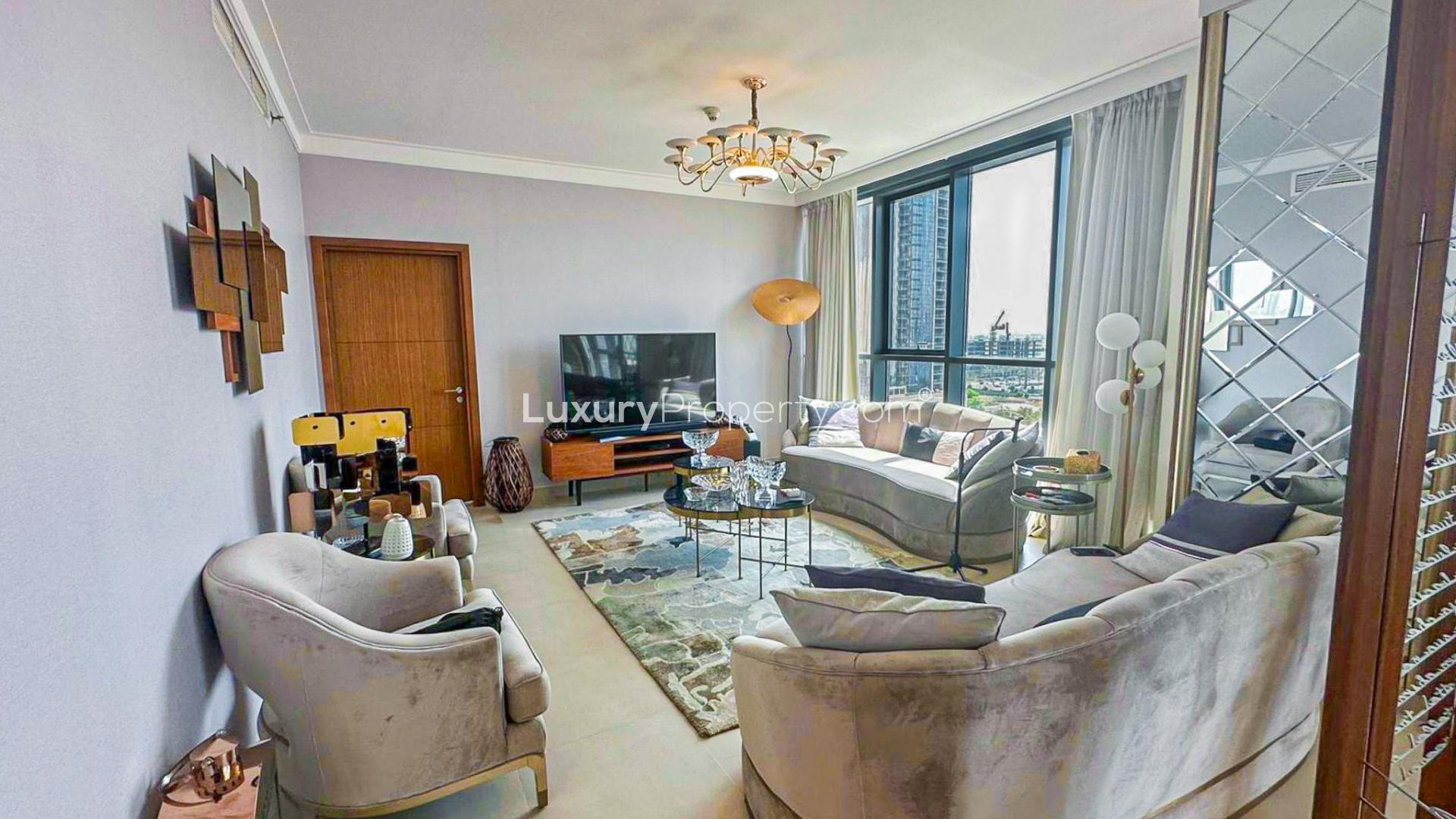 "Stunning creek view from furnished apartment balcony in Dubai Creek Harbour for sale.",Furnished living room in Dubai Creek Harbour apartment with modern decor and full creek view