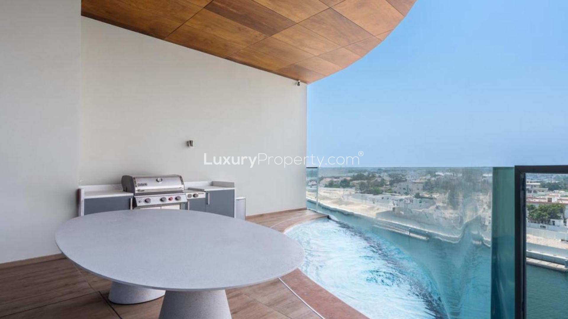 Modern living room in Jumeirah apartment, featuring elegant furniture and large windows
