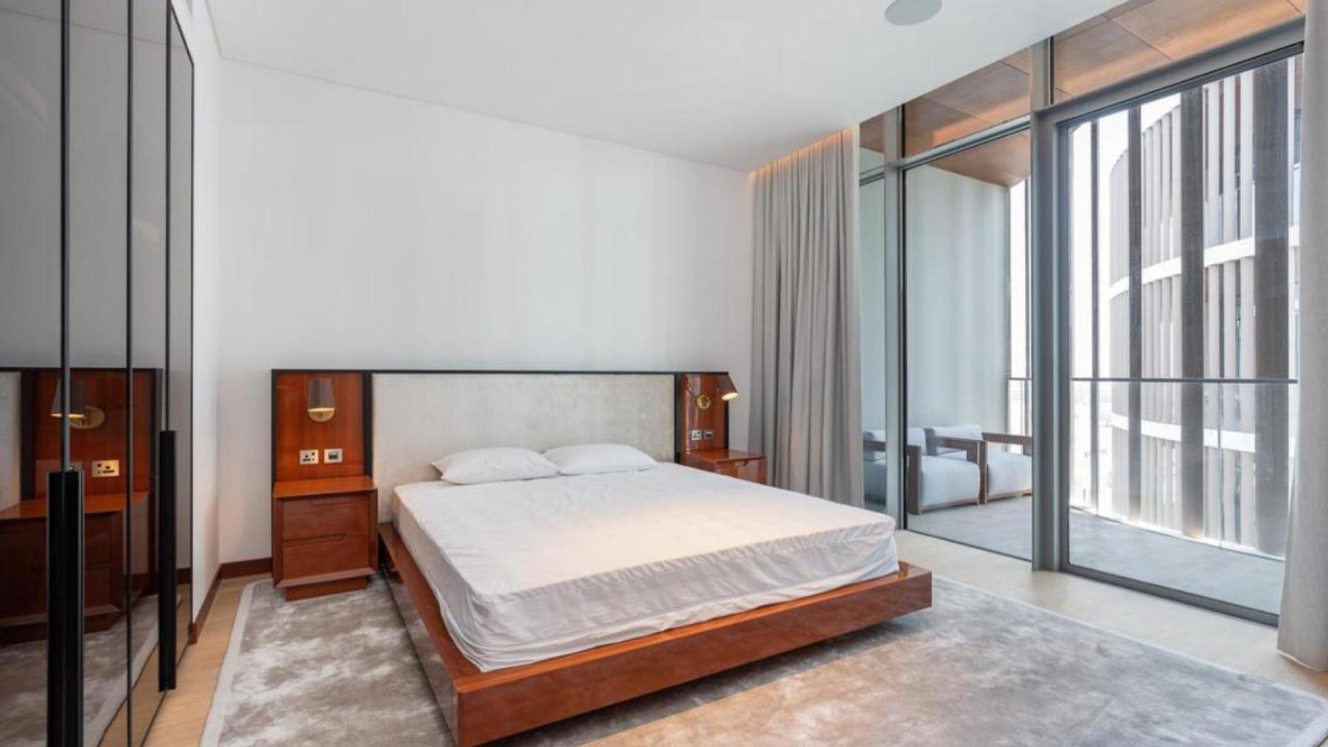 Luxurious balcony with barbecue, round table, and stunning sea view in Jumeirah apartment