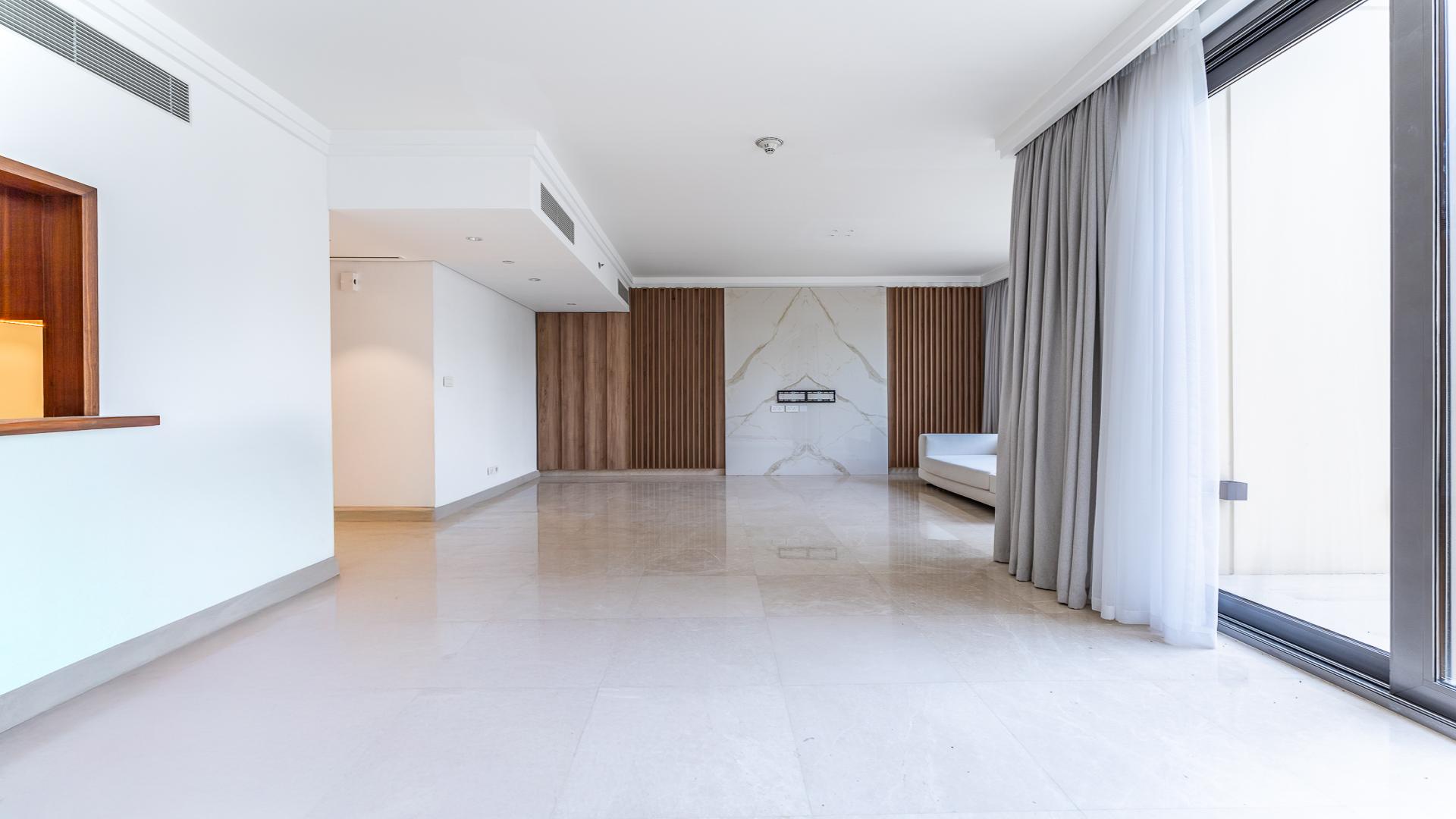 Spacious Downtown Dubai villa living room with garden view, modern design, and natural light