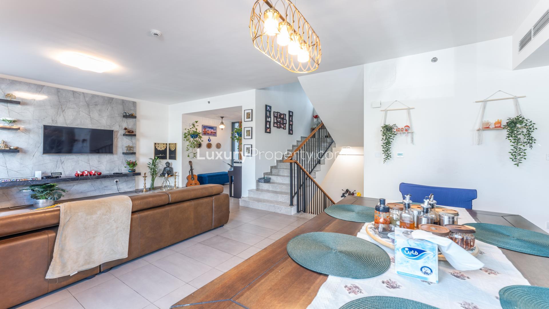 Contemporary living room in Executive Residences apartment, Dubai Hills Estate, with modern decor and greenery