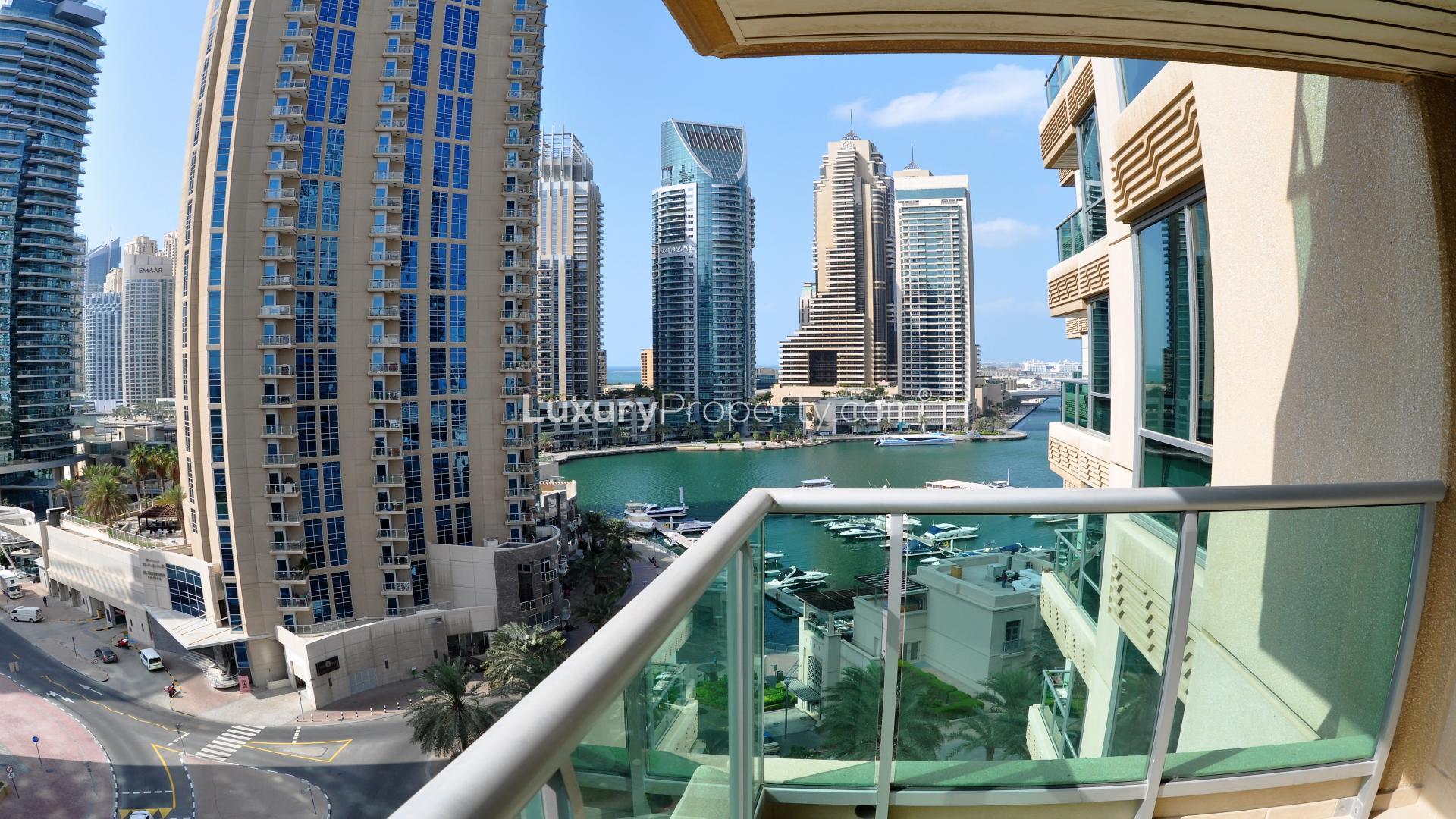 Bright living room with large windows and Marina view in Al Yass Tower apartment