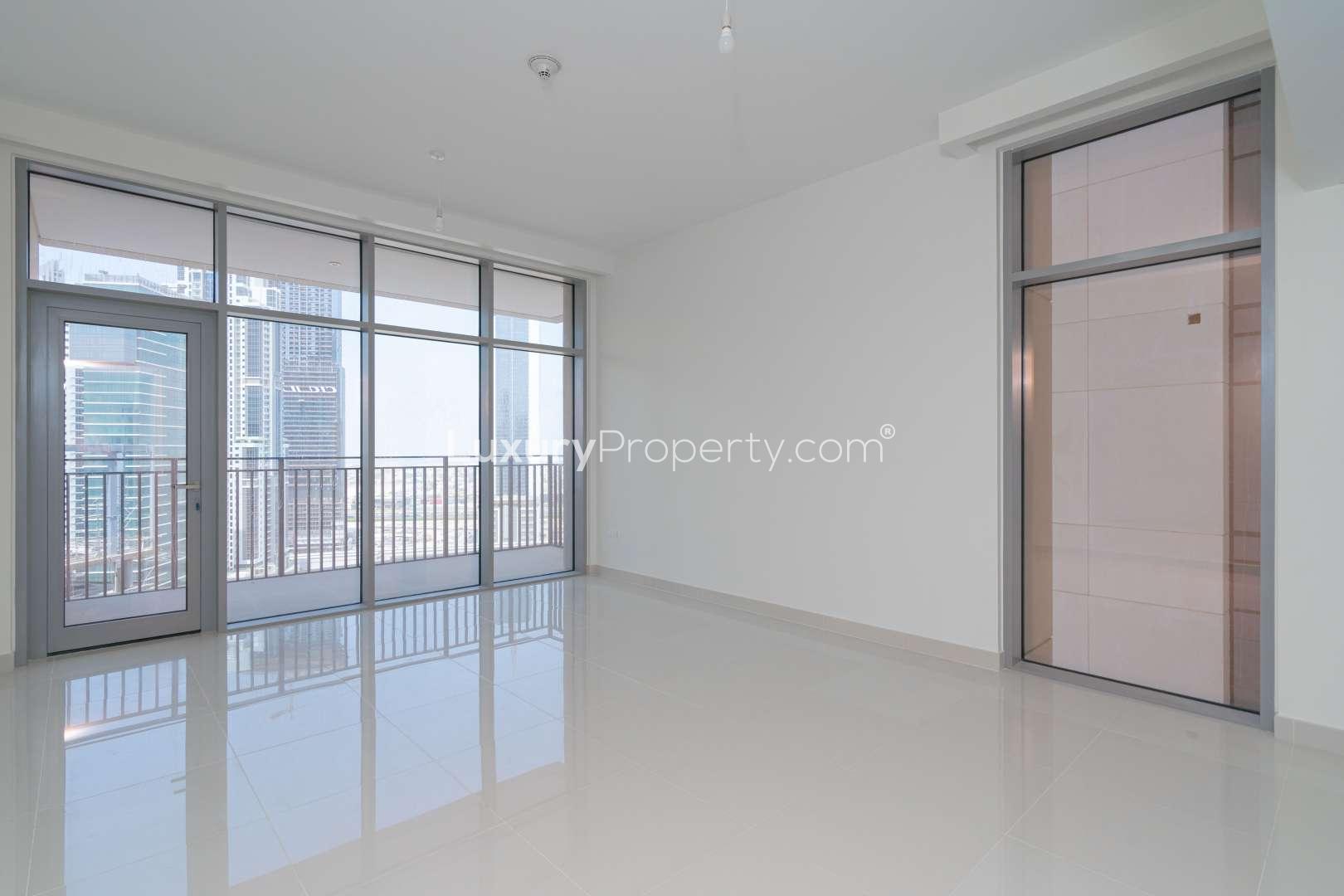 Bright living room with floor-to-ceiling windows, Downtown Dubai views at BLVD Crescent apartment