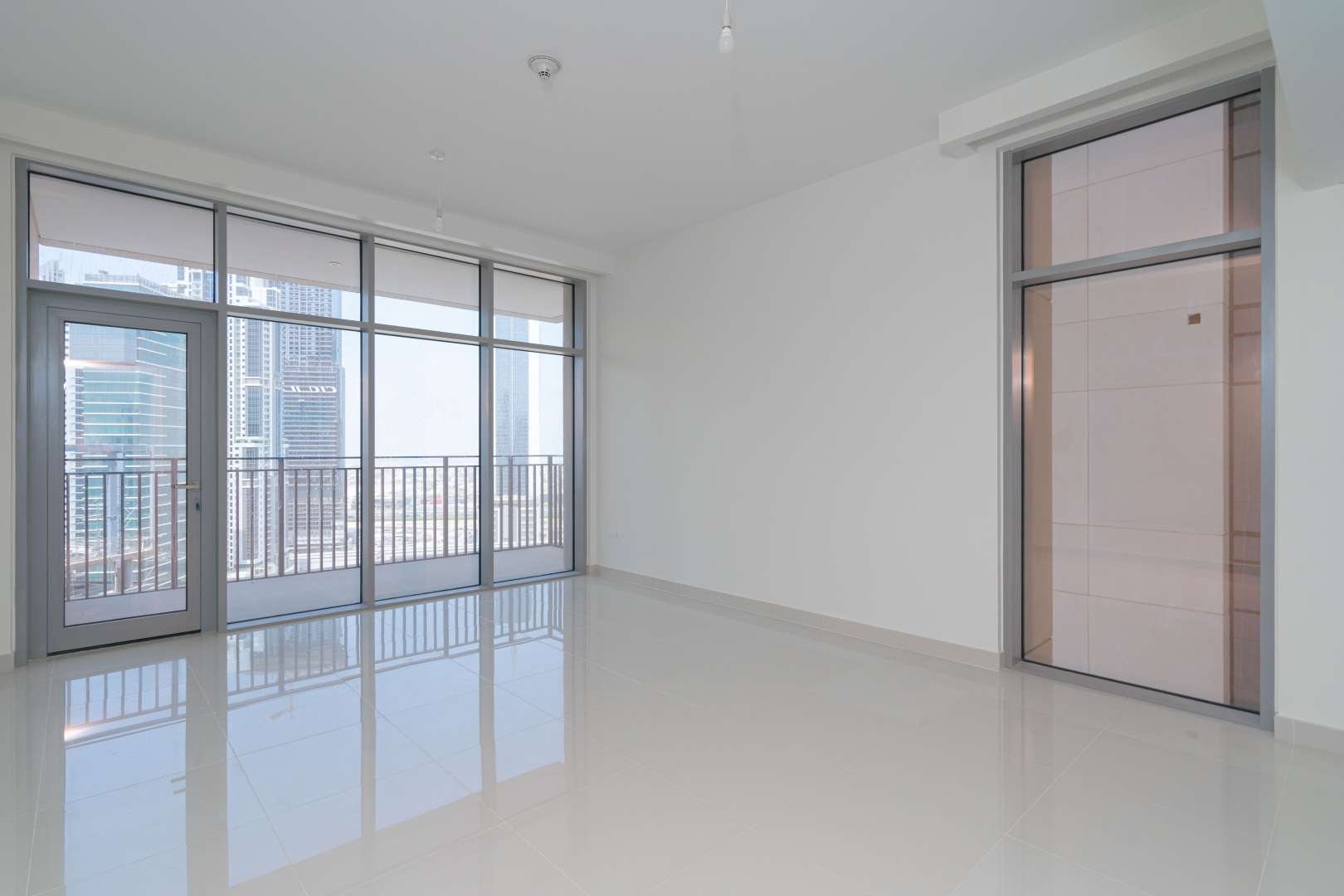 Bright living room with floor-to-ceiling windows, Downtown Dubai views at BLVD Crescent apartment