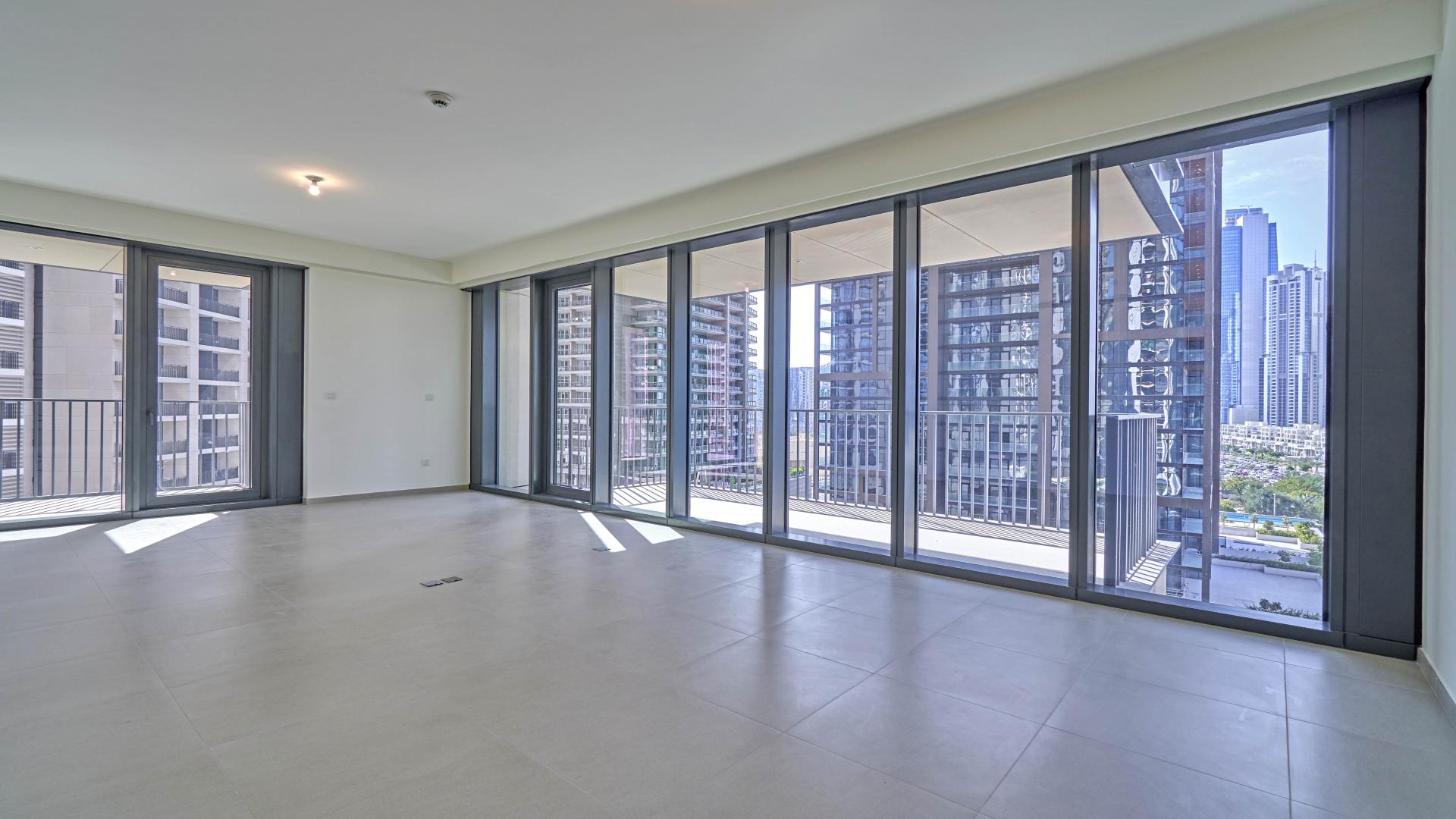 Spacious apartment interior with floor-to-ceiling windows and downtown Dubai skyline views