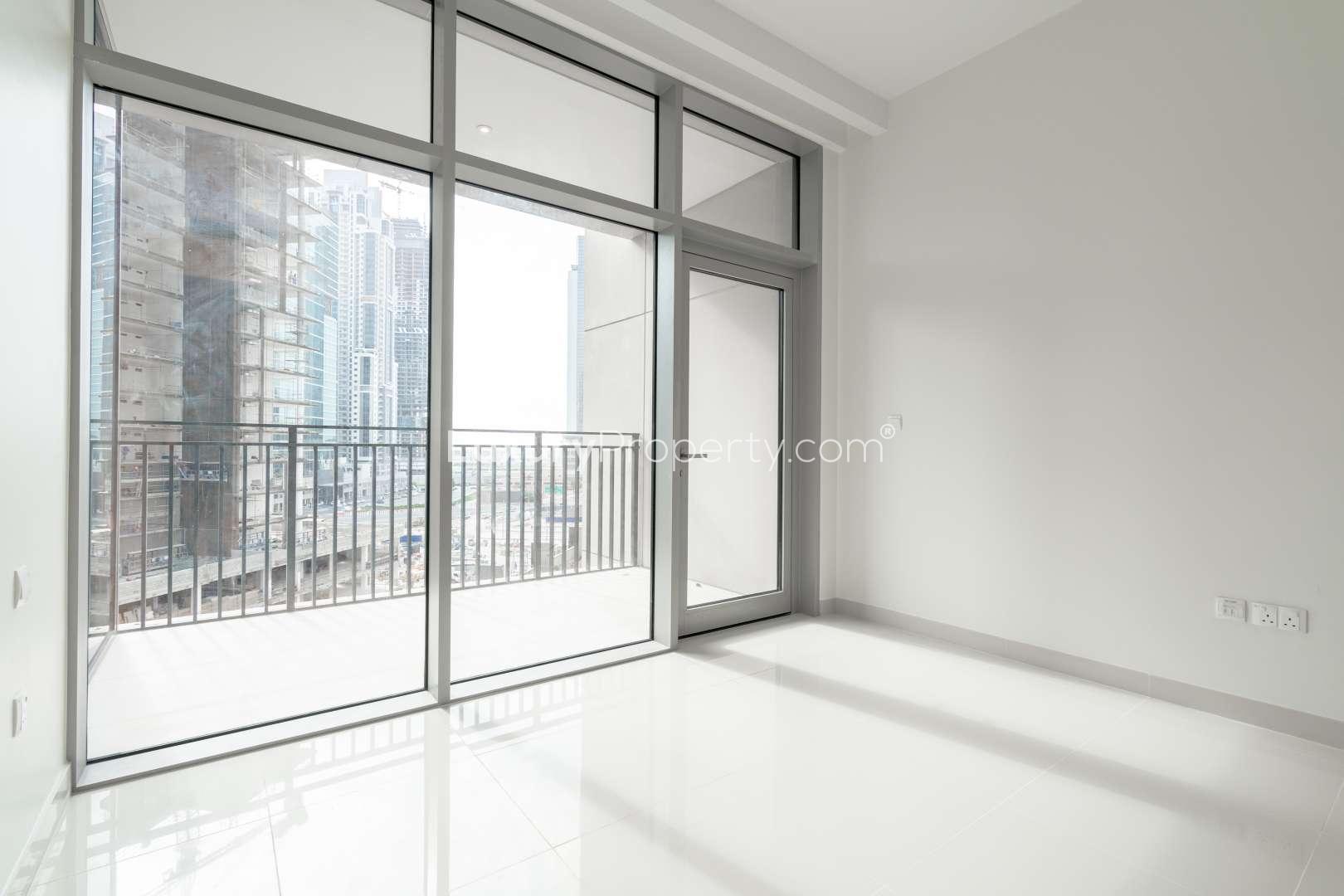 Bright living area with large windows in Boulevard Crescent apartment, Downtown Dubai
